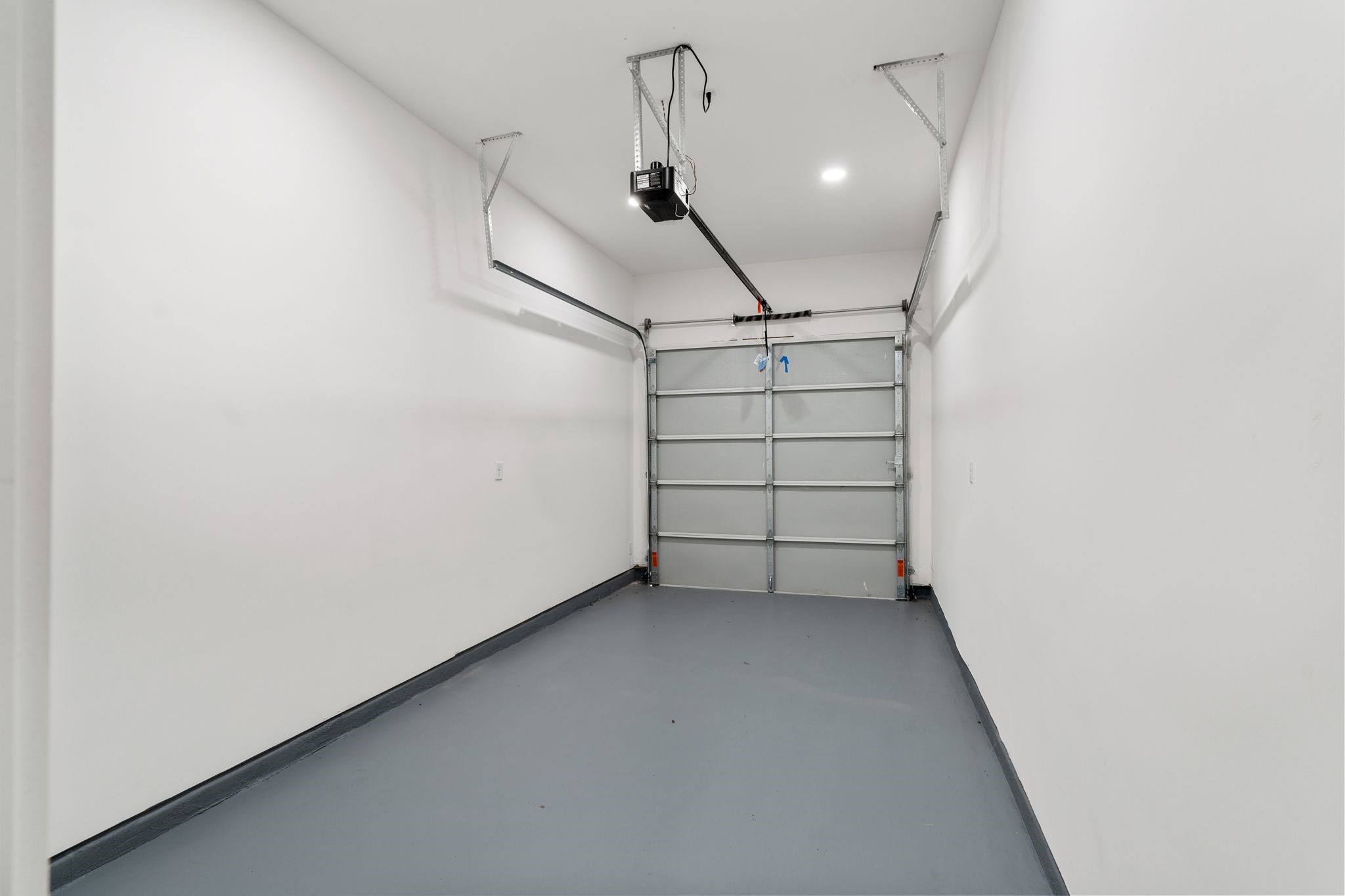 View of the one car garage. With entry directly in to the living room. Garage floors are completed with epoxy floors.