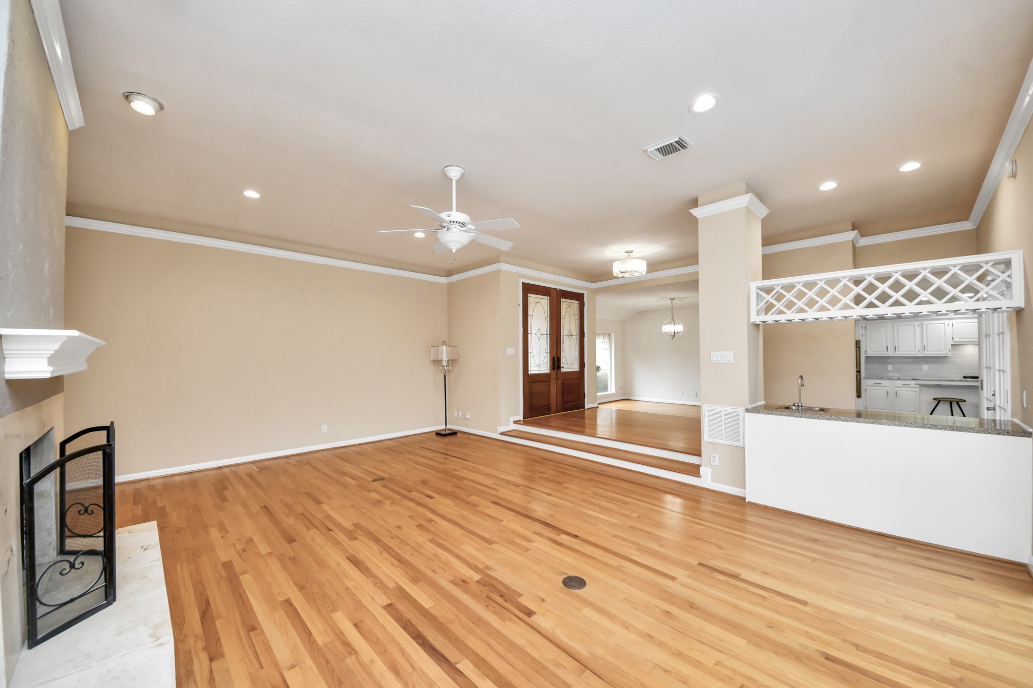 Unstaged view highlights the size of the living room and its open connection to the entry, dining area and wet bar.
