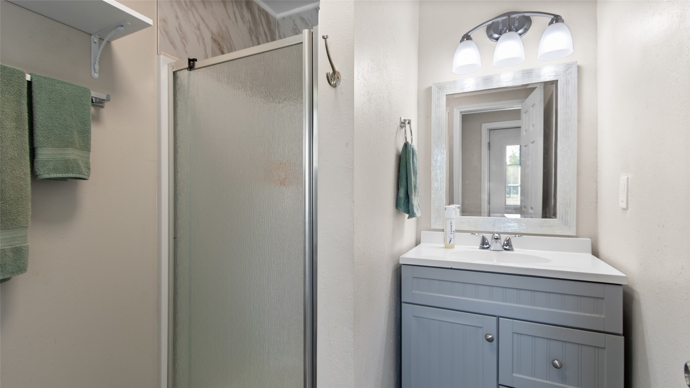 Bathroom with standing shower only in converted garage apartment
