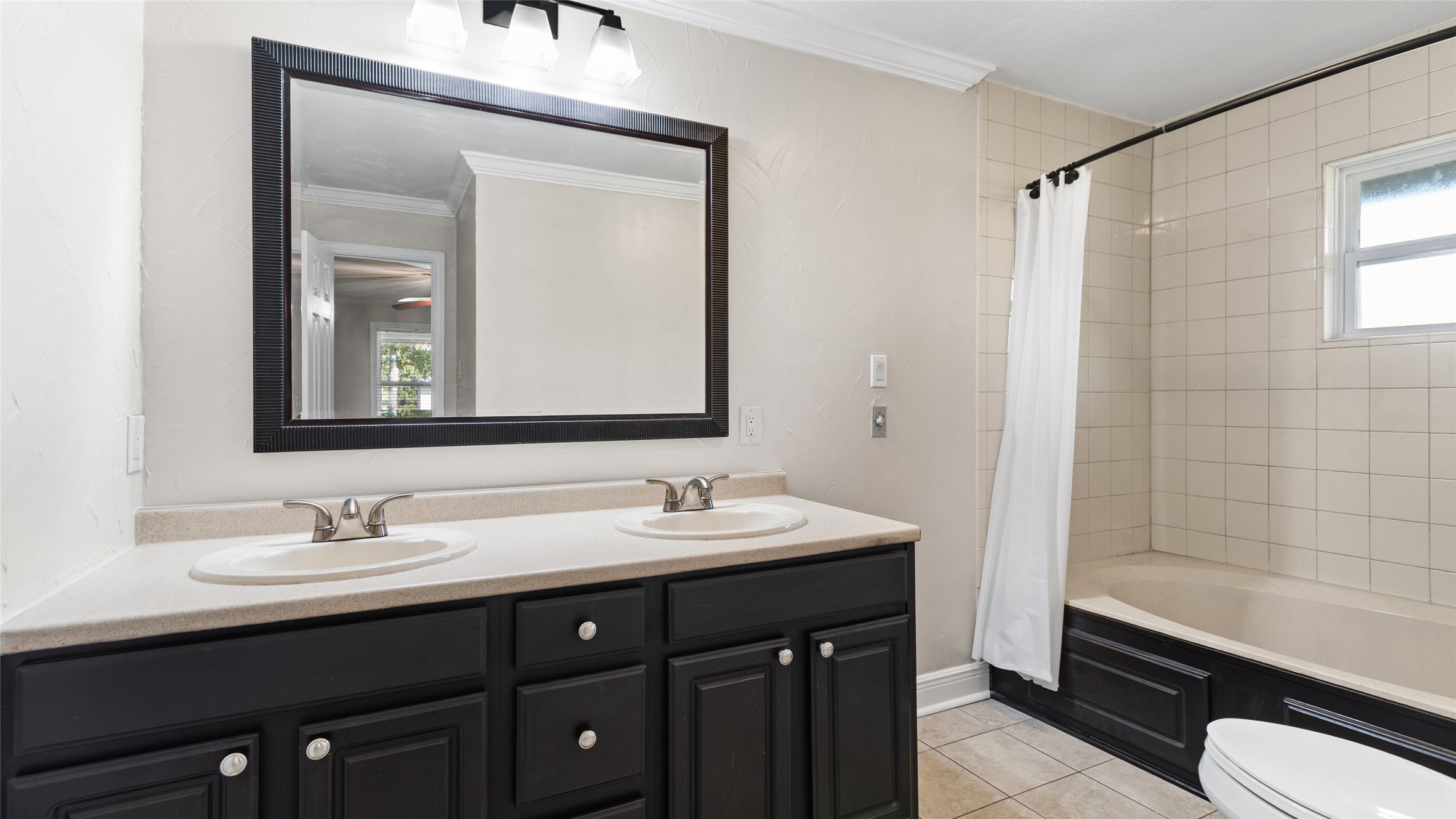 Second bathroom with double vanities & tub/shower combo