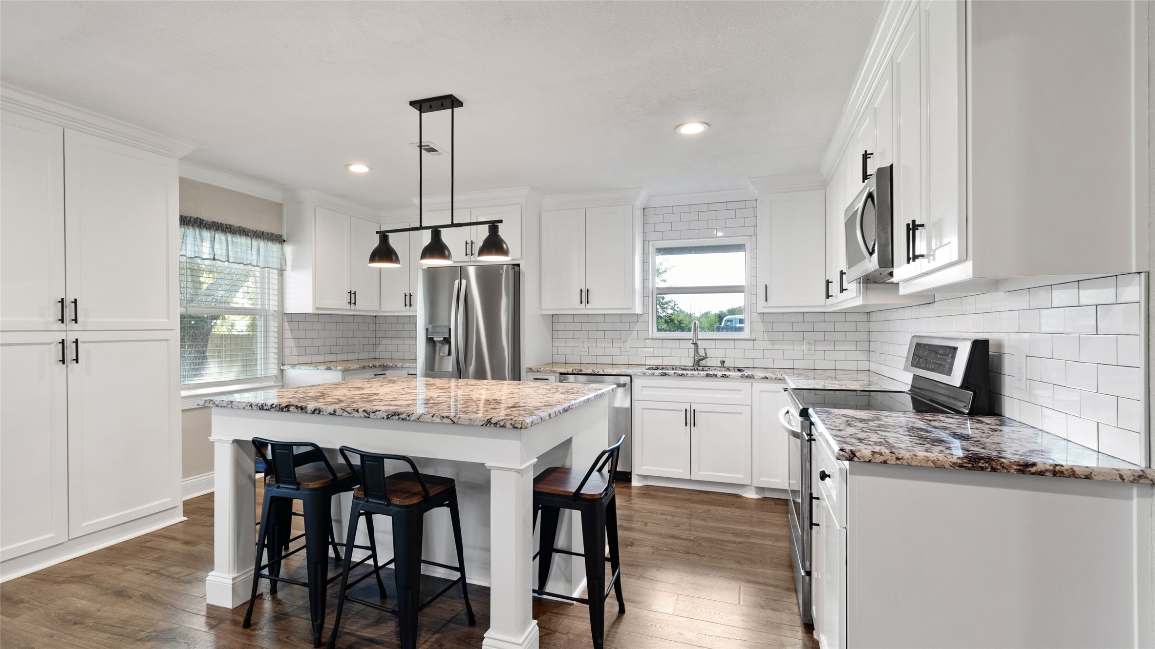 Kitchen with island and stainless steel appliances Kitchen with island and stainless steel appliances
