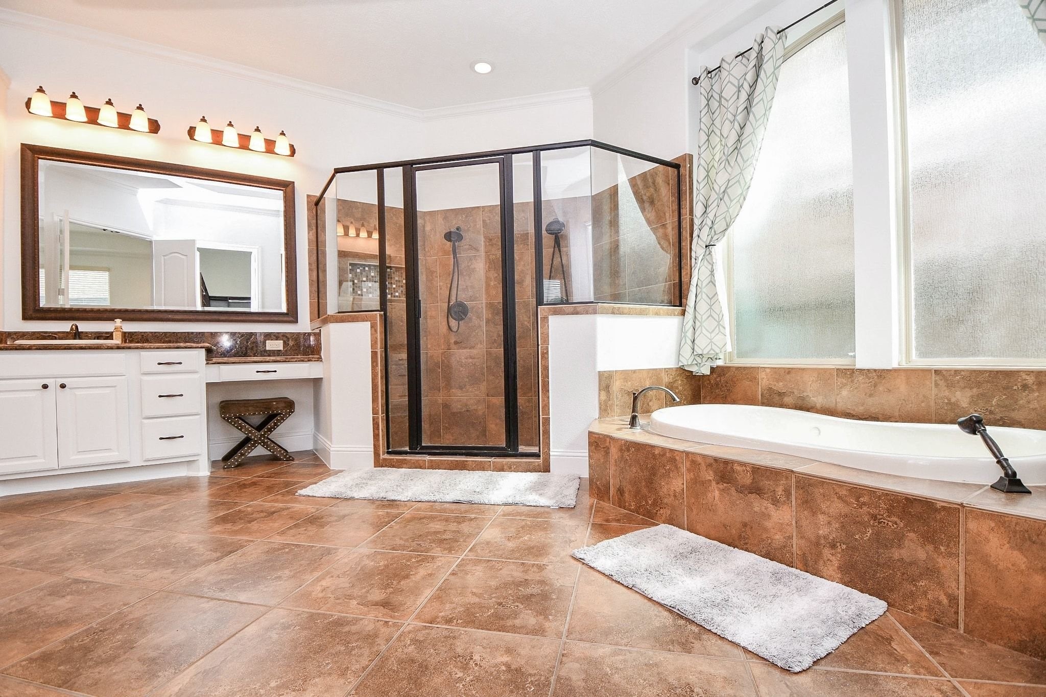 Primary bath has double headed shower, jetted soaking tub...