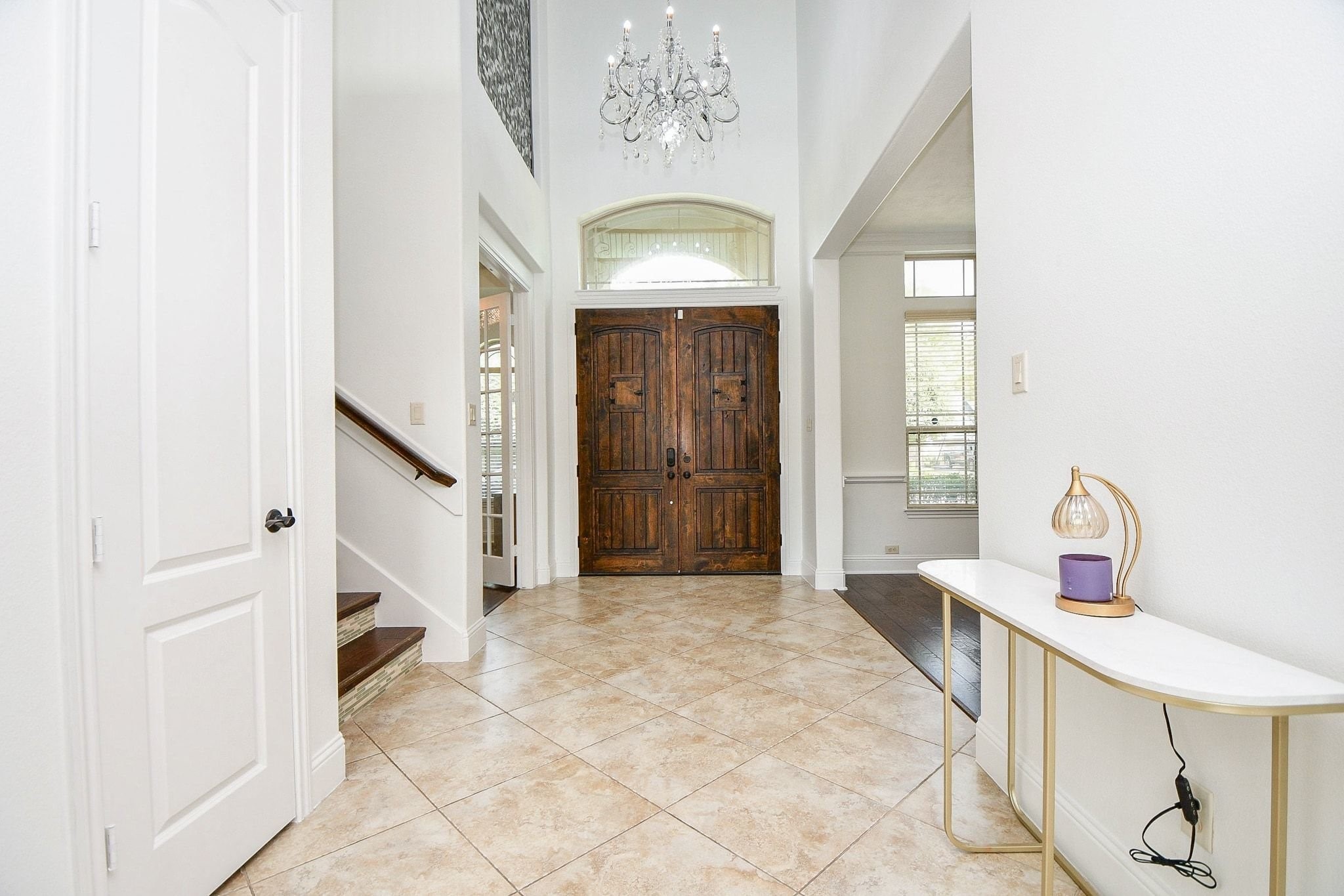 2 Story Entry, with tile flooring and huge chandelier