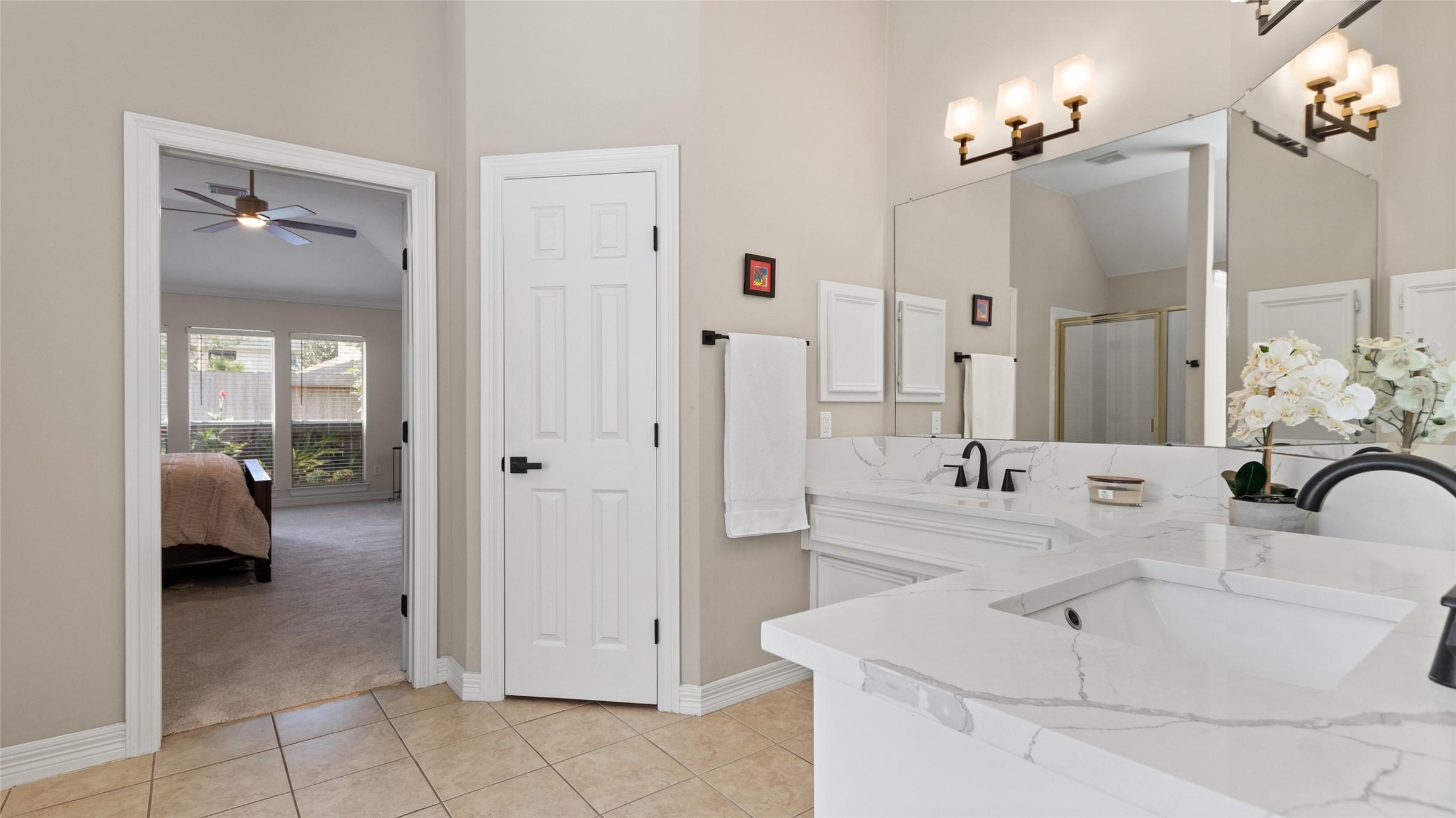 The quartz countertops continue in here, as well as updated lighting & fixtures.