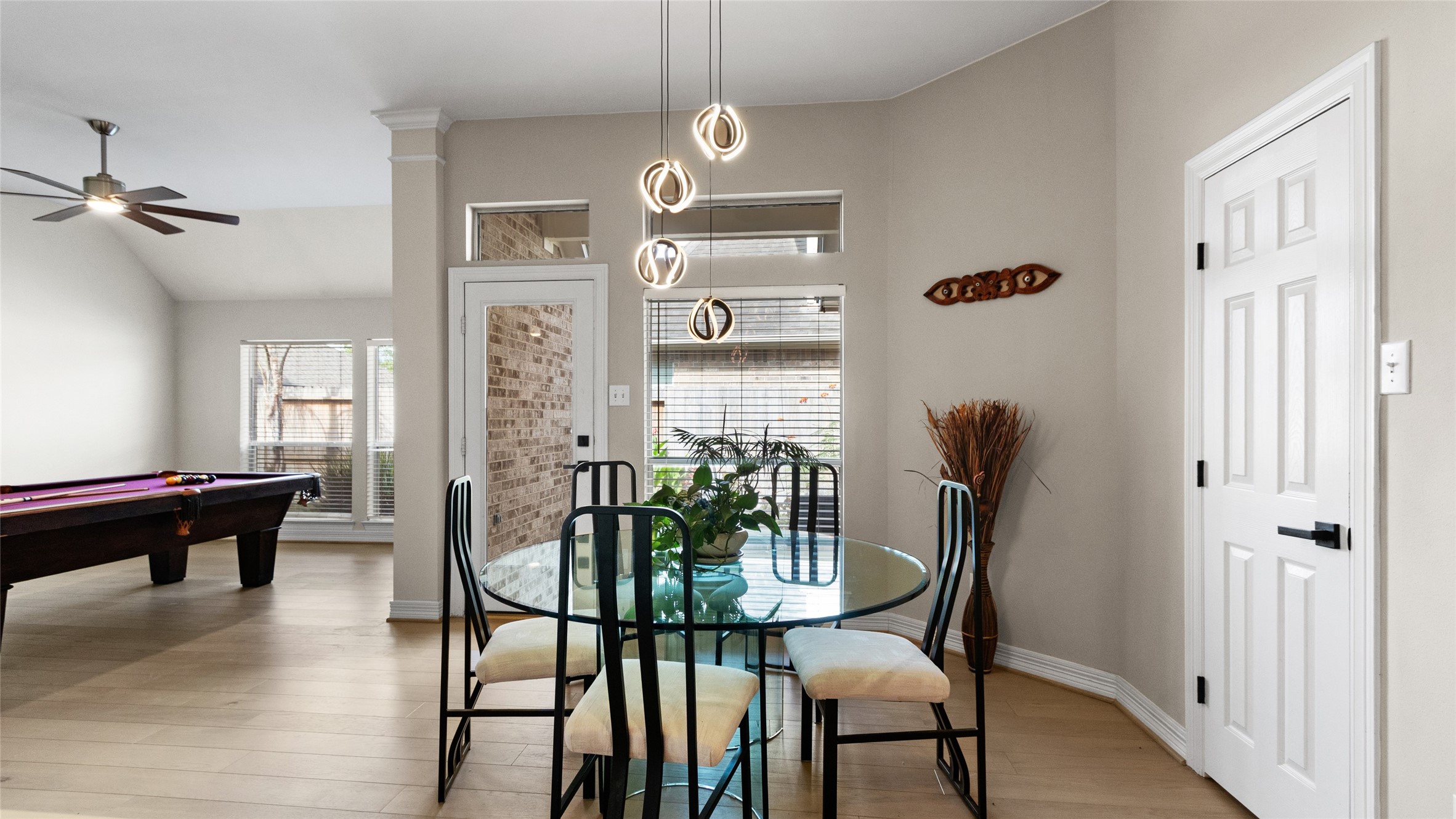 The breakfast area off of the kitchen leads to the game room.