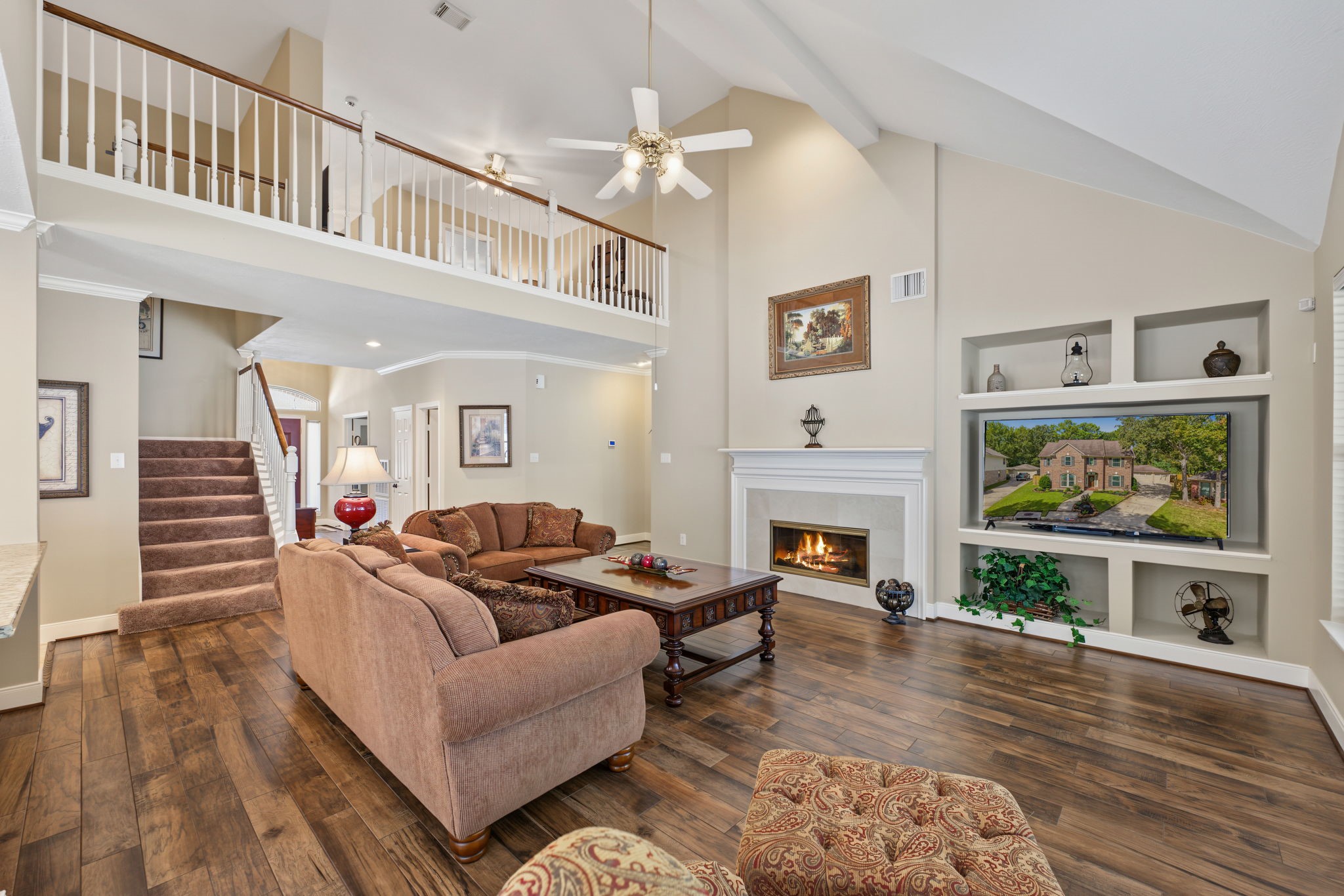 The vaulted ceilings make this Family Room feel even larger. Wood-look tile flooring throughout.