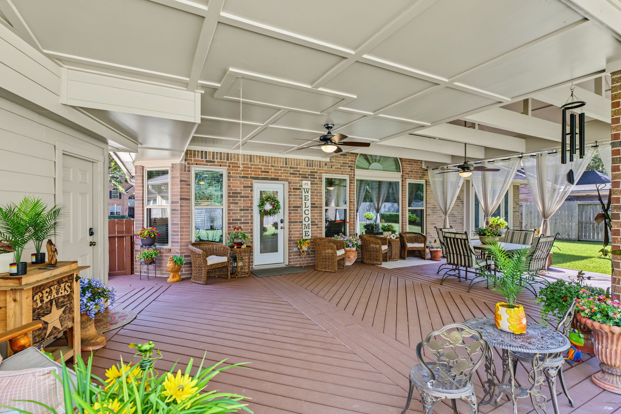 View from one corner of the back patio looking back at the deck. You can see the attic staircase better here.