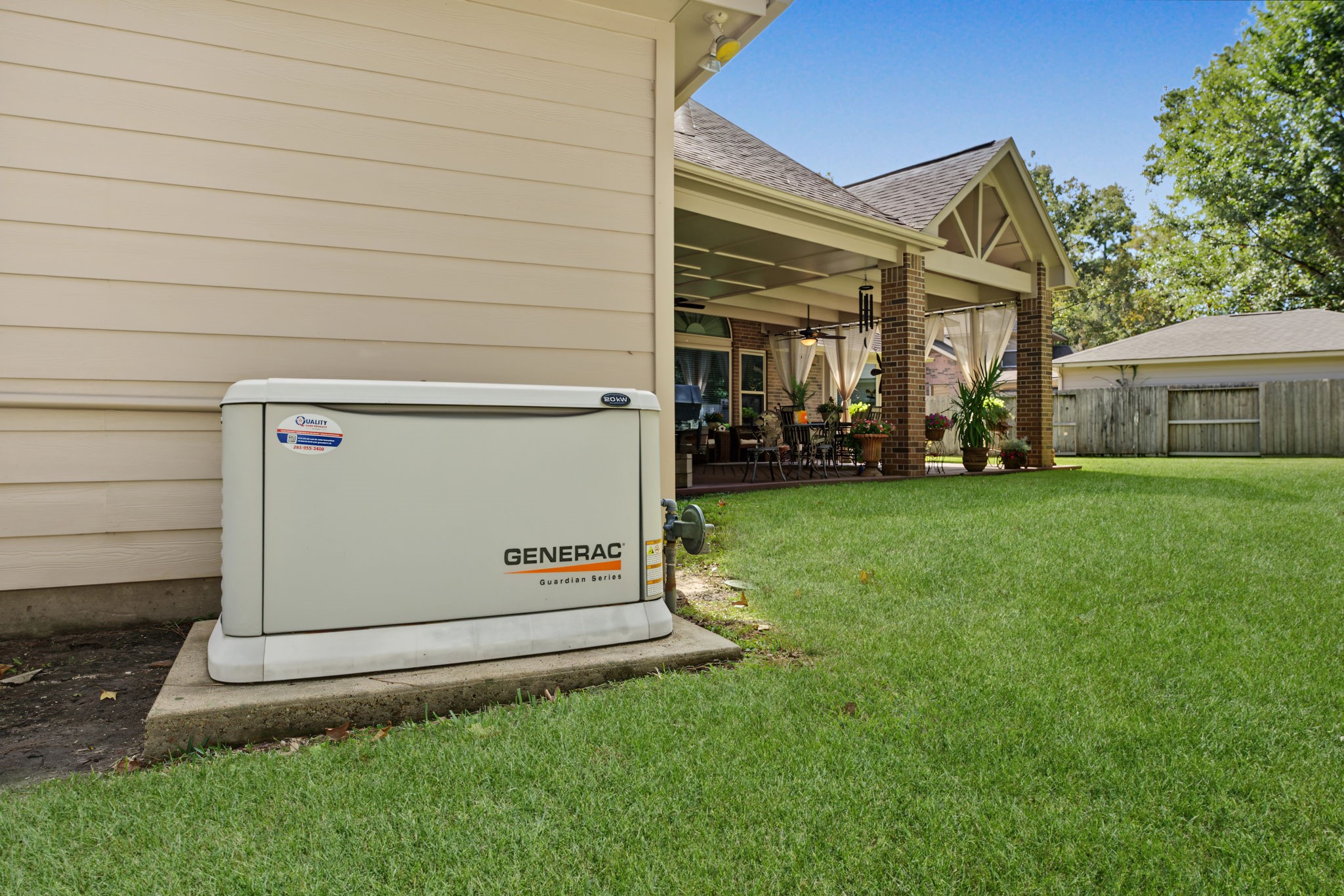 Generac whole-home generator is located behind the garage.