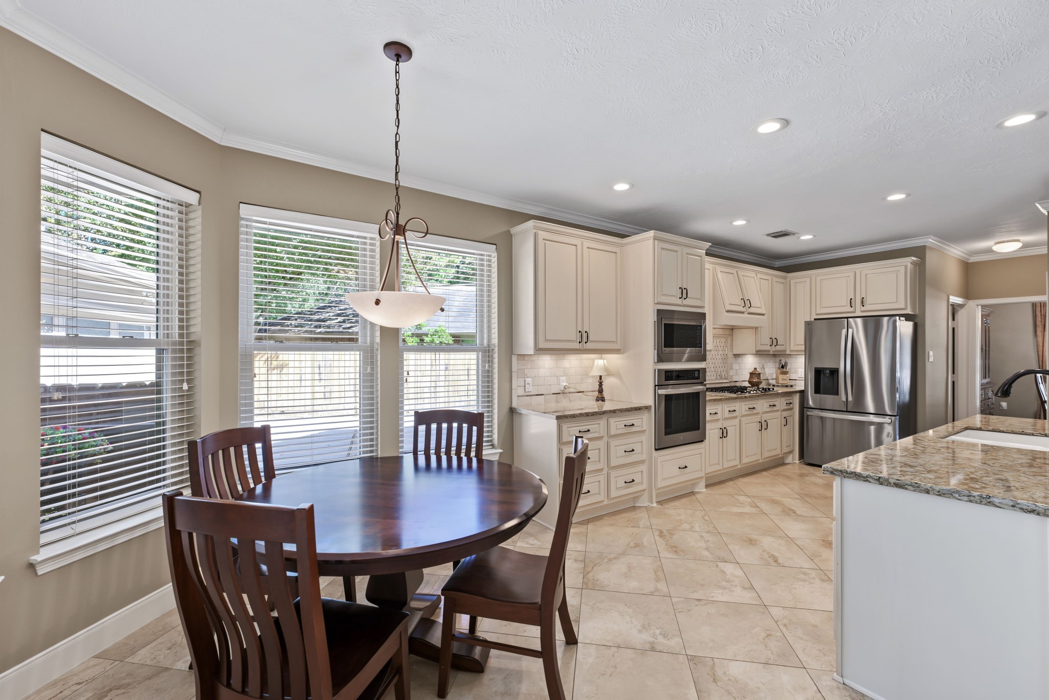 The breakfast area overlooks the backyard, driveway, and family room.