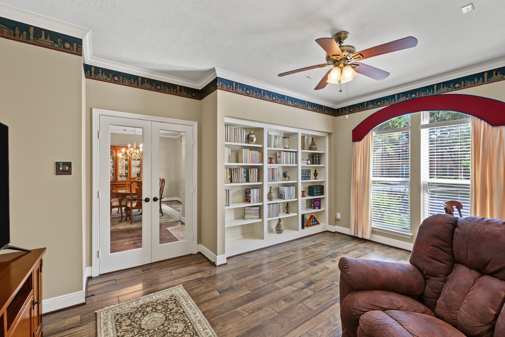 This front Study/Office is large at approx 17' x 11' with double French doors and built in shelving.