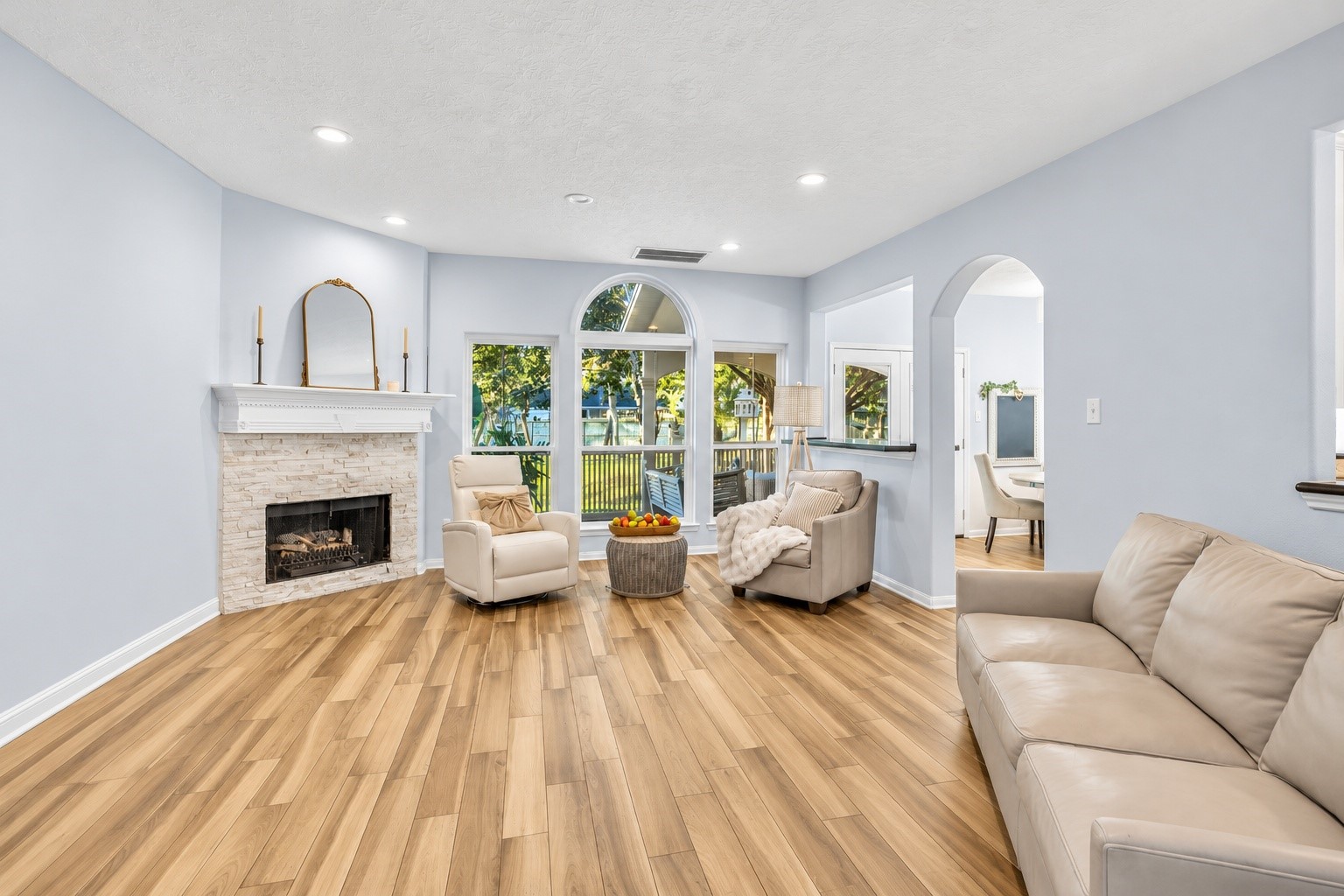 Incredible natural light fills this main living space. Recently updated backsplash on the fireplace is a wonderful touch. Incredible natural light fills this main living space. Recently updated backsplash on the fireplace is a wonderful touch.
