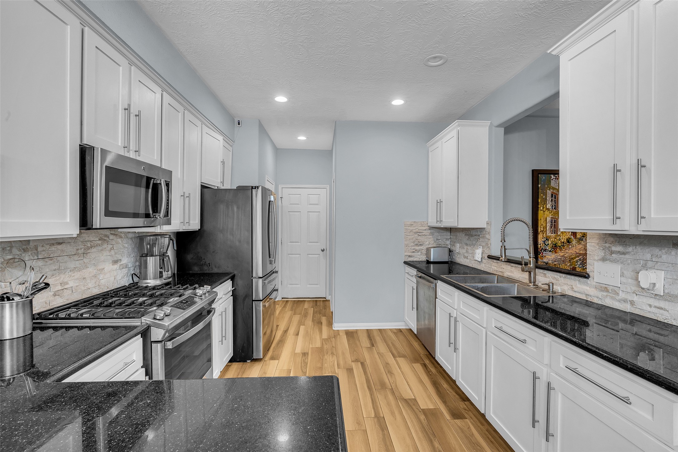 Stainless steel appliances and granite counters set the stage for the cooking show.