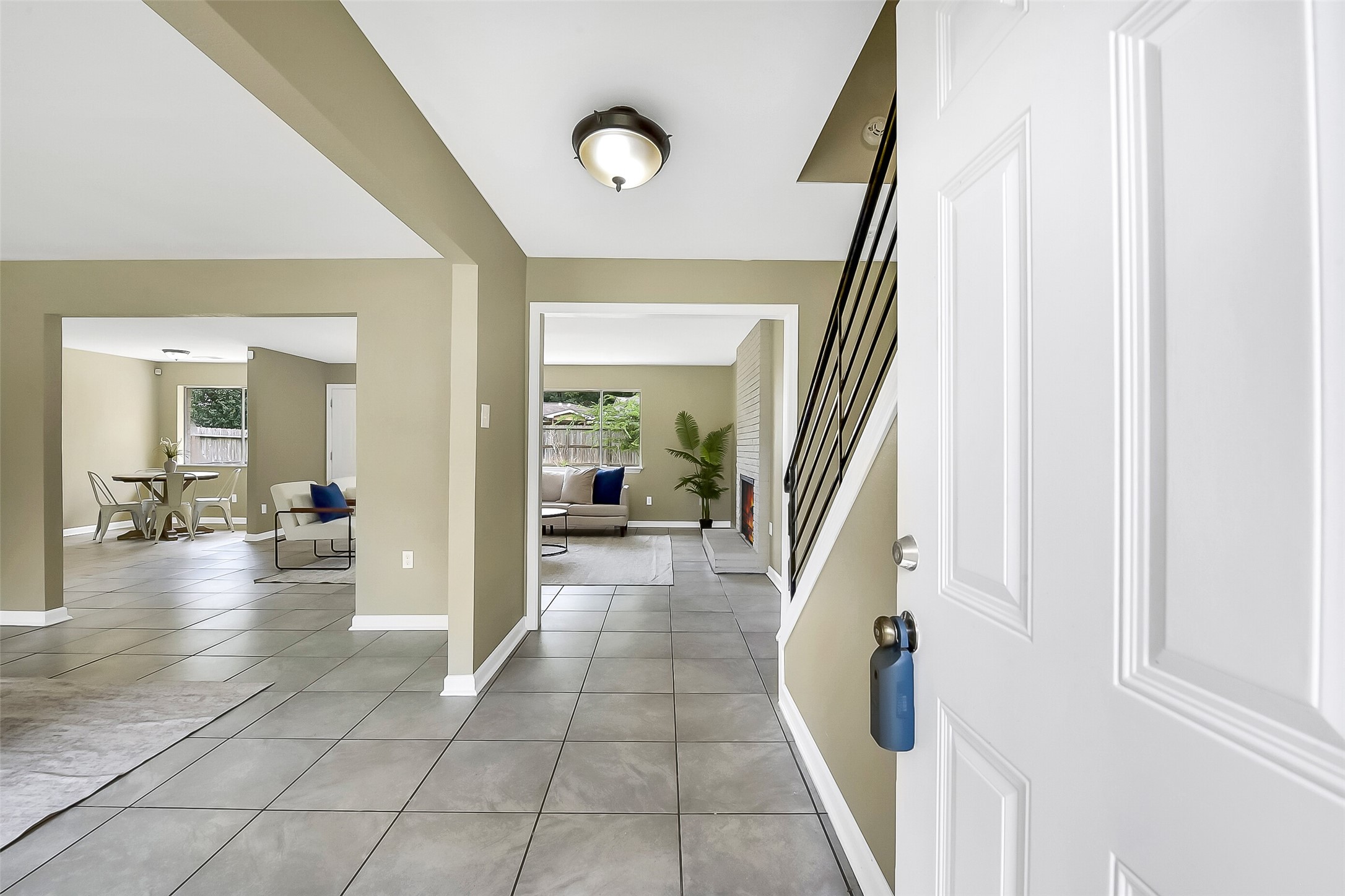 Step inside to find fresh neutral paint, easy-maintenance tile flooring, and an open floorplan that flows seamlessly from the entry into the main living areas.