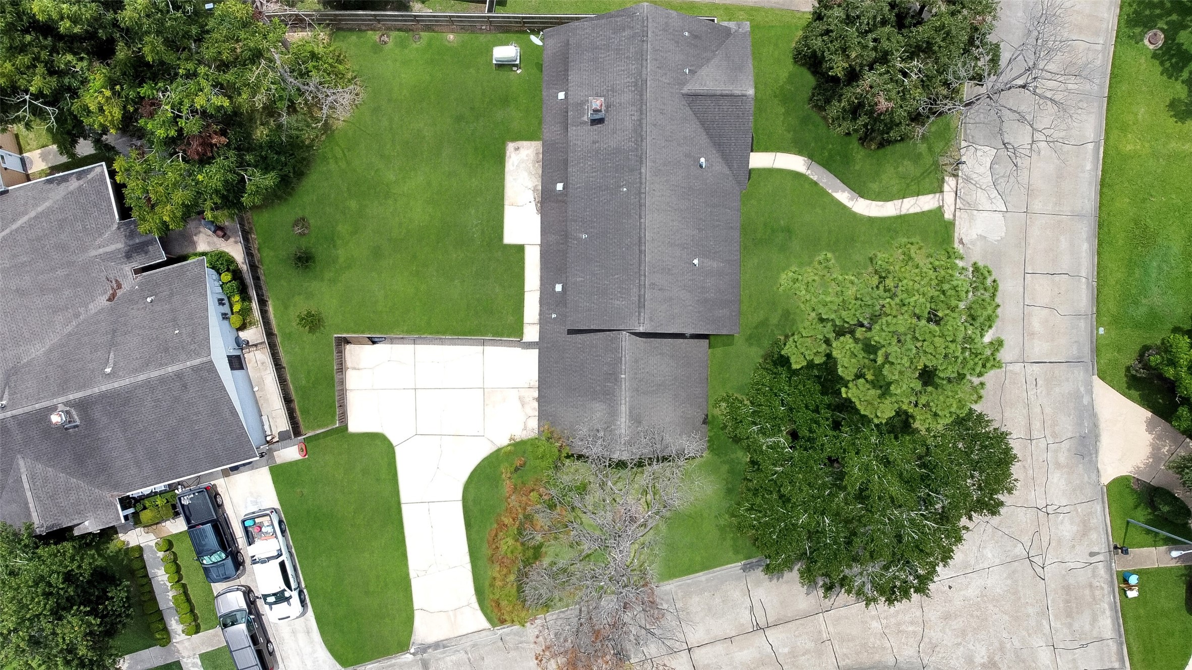 Aerial views showcase this spacious 2-story home on a large corner lot with mature trees, fenced backyard, and prime Wedgewood Village location in CCISD.