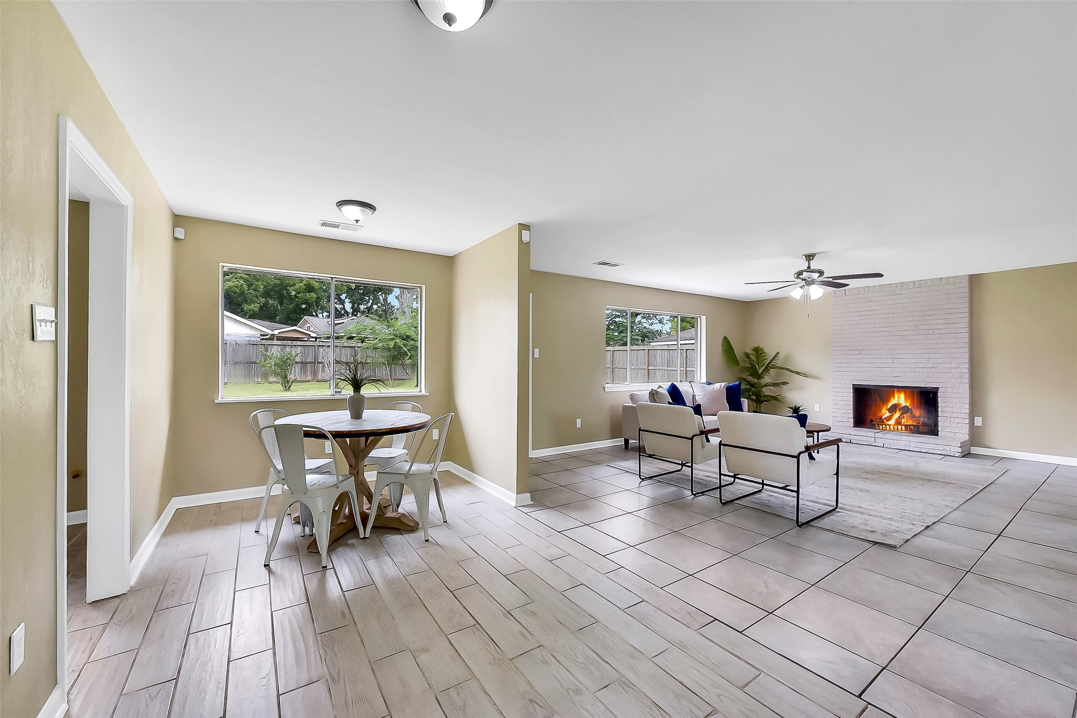 This light & bright breakfast nook with wood-look tile floors and large windows overlooking the backyard is situated between the family room, the indoor utility room, and the kitchen.