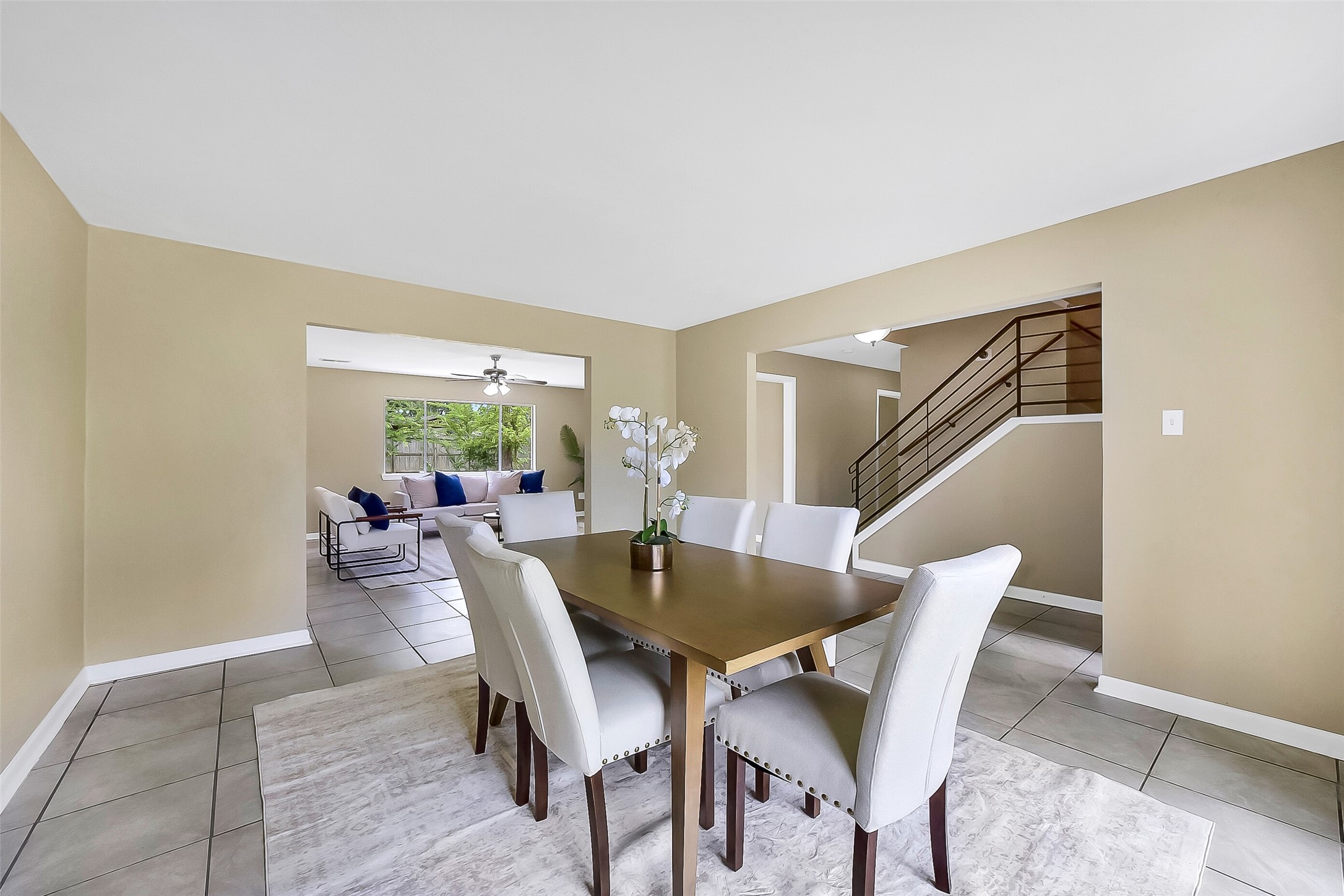 The formal dining room features tile flooring, neutral paint, and a spacious layout that flows easily into the living room and foyer - making it the perfect home for gatherings and entertaining.