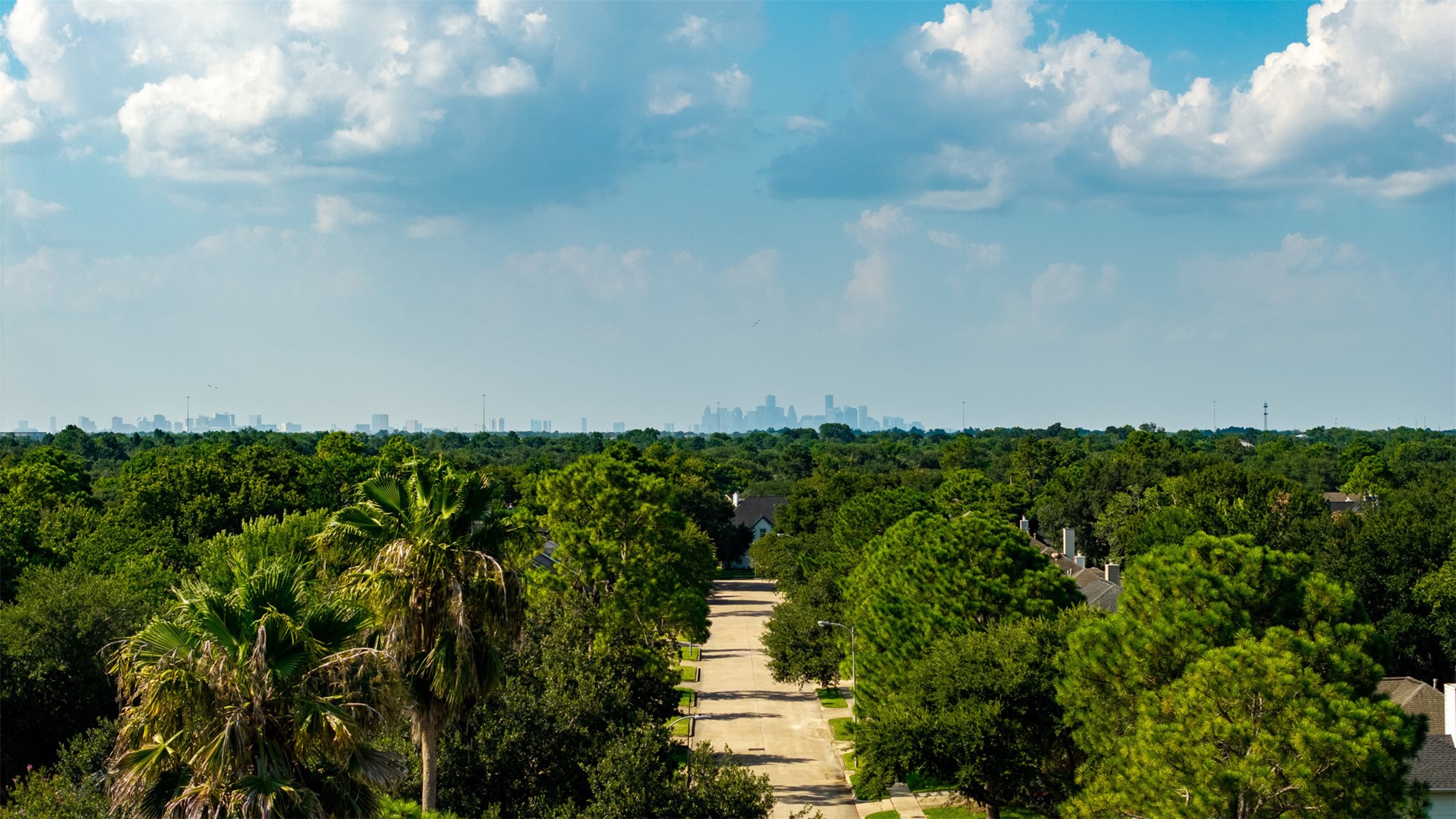 Aerial perspective highlights the lush canopy of majestic trees surrounding this neighborhood with sweeping views of the distant Houston skyline. Convenient location offers an easy commute to the Medical Center along with short distance to top dining and retail options.