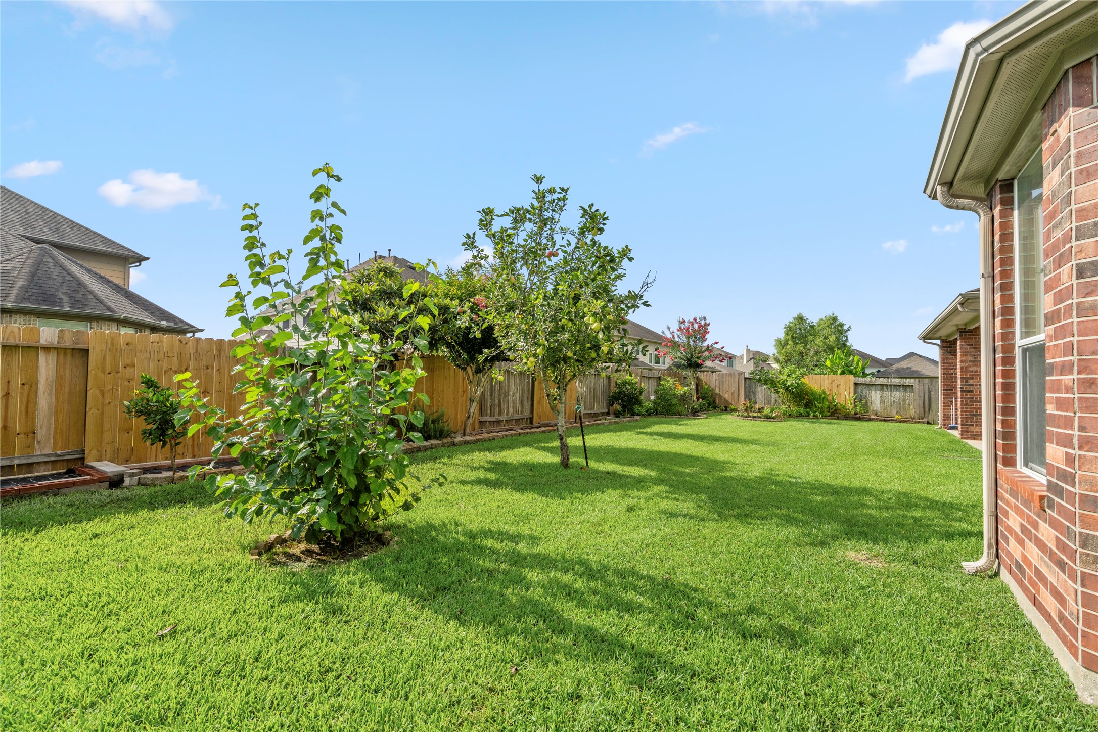 A peaceful, fruit-tree-dotted lawn provides the ideal backdrop for outdoor gatherings, gardening, or quiet relaxation in this private retreat.