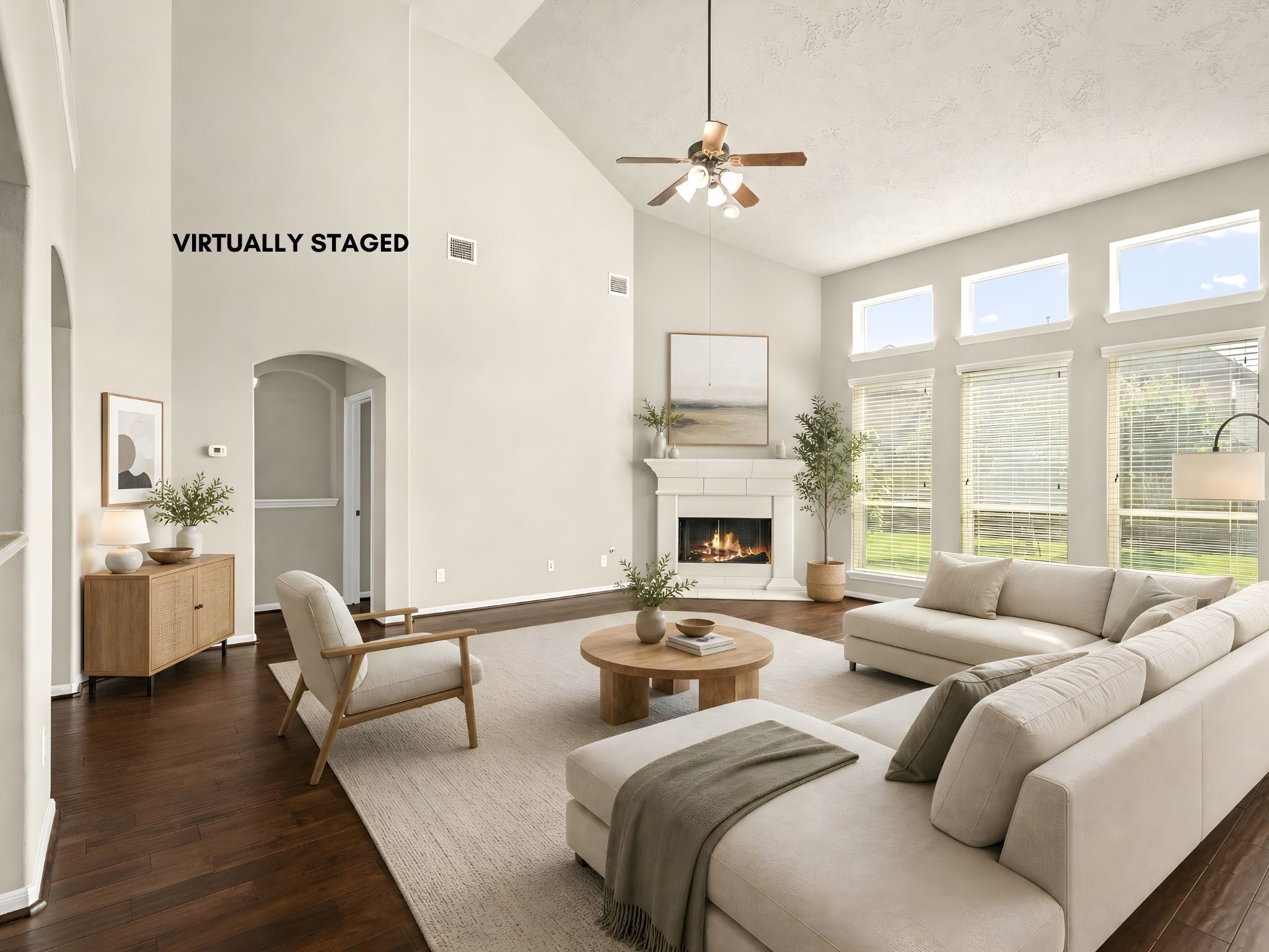 Soaring two-story ceilings and a striking gas fireplace anchor this beautifully virtually staged family room, designed to inspire grand-scale gatherings and relaxed evenings alike. Soaring two-story ceilings and a striking gas fireplace anchor this beautifully virtually staged family room, designed to inspire grand-scale gatherings and relaxed evenings alike.