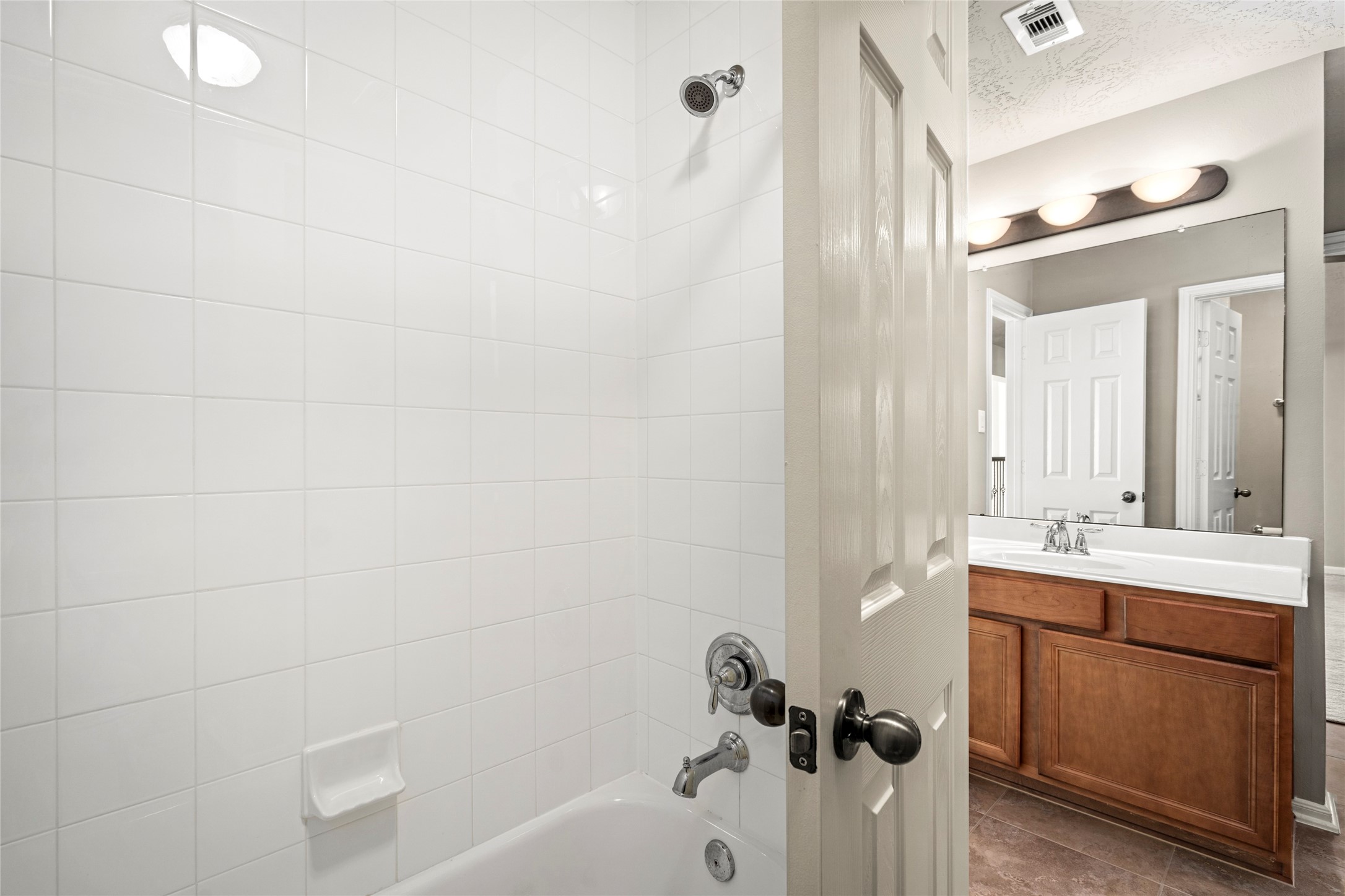 A well-appointed secondary bath features a tub/shower combo and tile flooring, completing this thoughtfully designed upstairs layout.