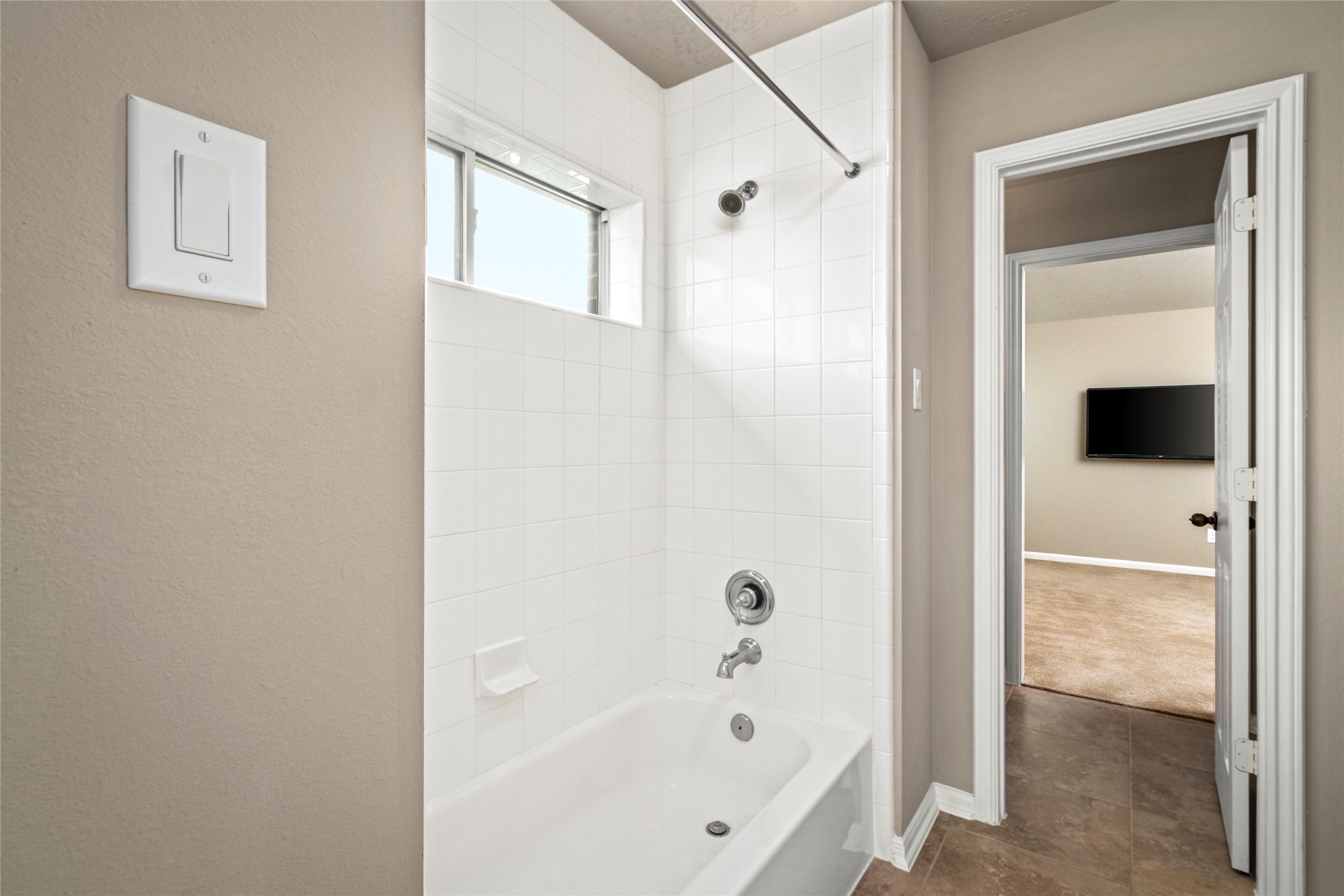 A well-appointed secondary bath features a tub/shower combo and tile flooring, completing this thoughtfully designed upstairs layout.