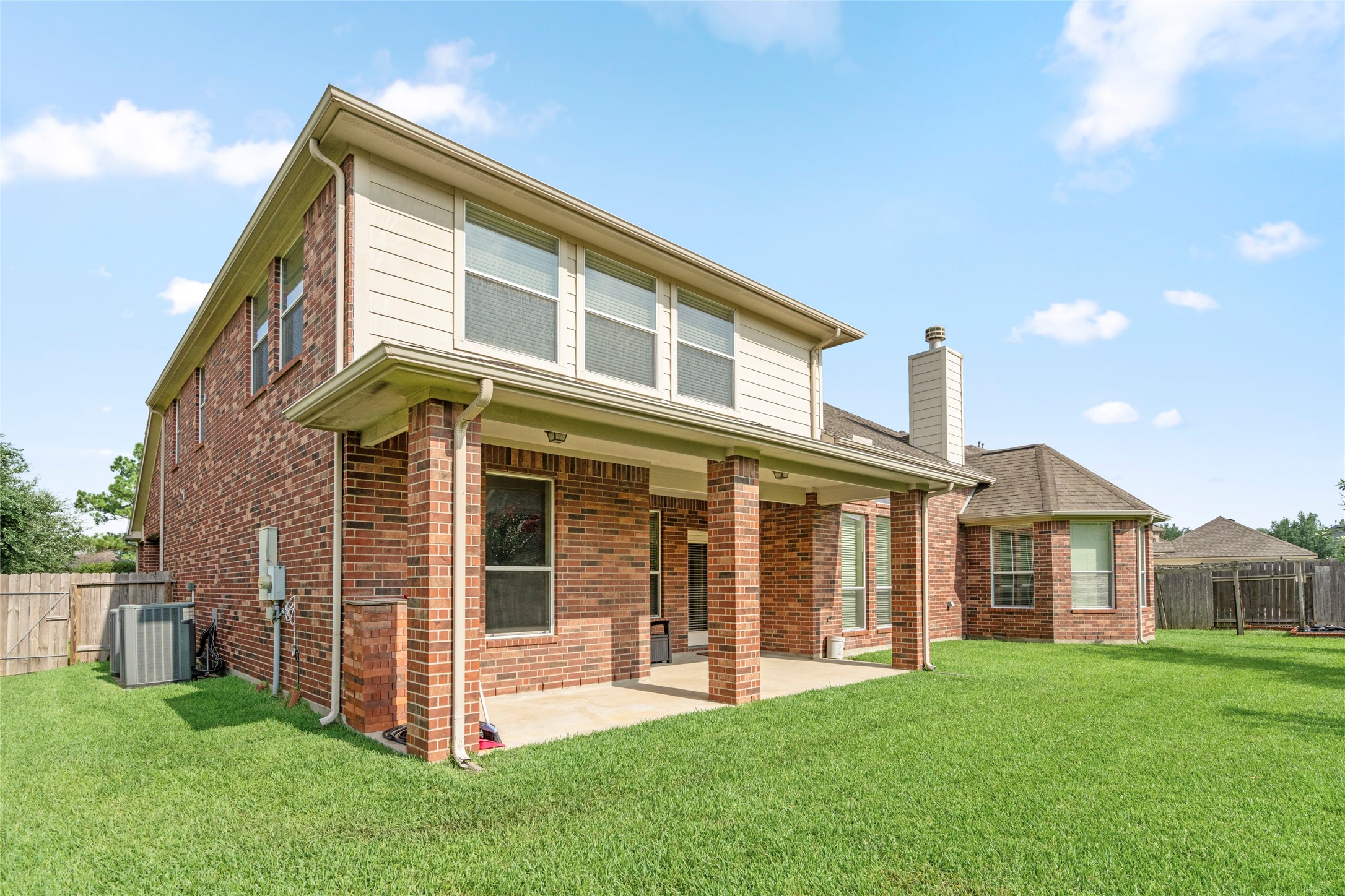 Framed by a privacy fence and verdant landscaping, this generous backyard offers the space and serenity to entertain, relax, or simply enjoy Texas evenings.