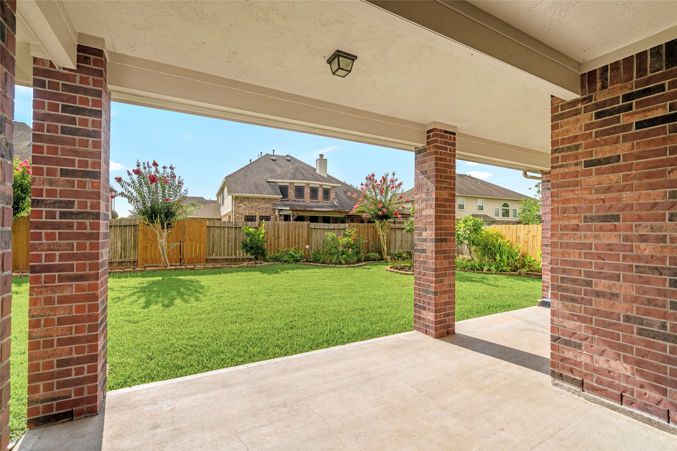 A tranquil outdoor escape with lush landscaping and mature trees sets the scene for memorable evenings under the Texas sky.