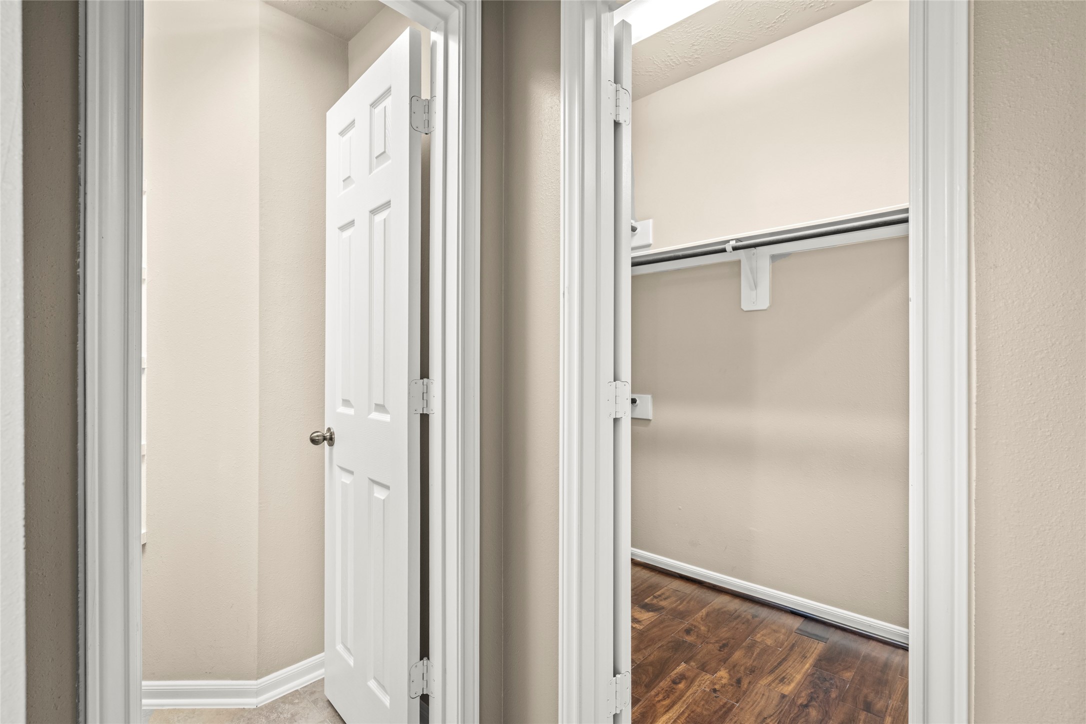This photo shows the entrance to the walk-in closet and ensuite bath of the primary bedroom.