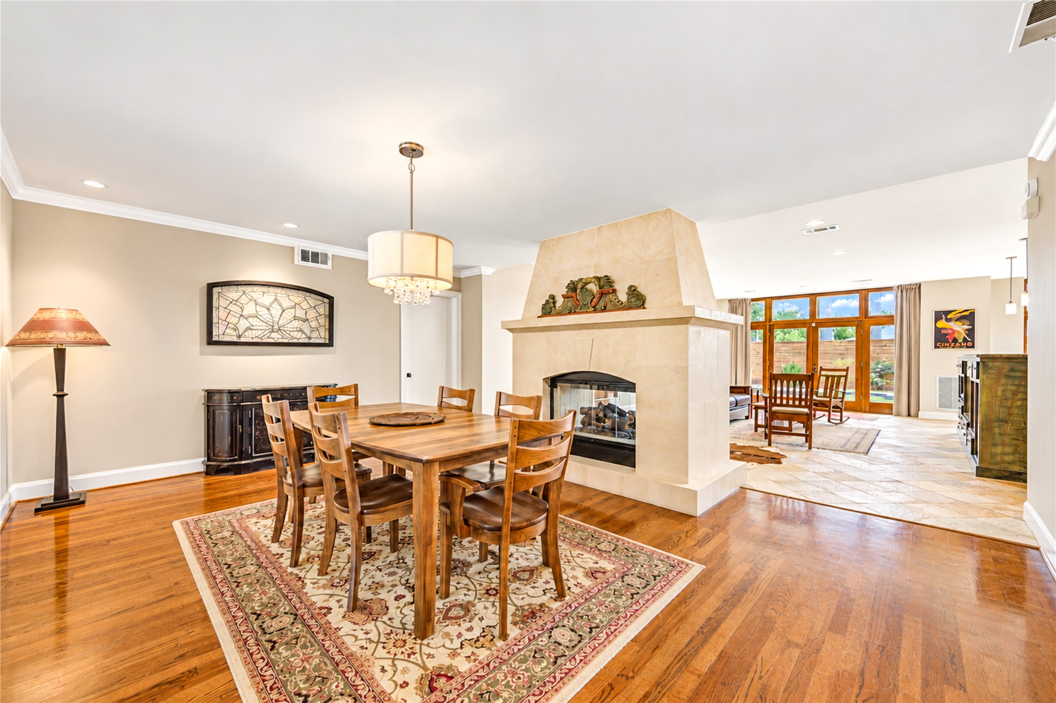 A two-sided fireplace connects the dining and family rooms, while expansive windows fill the spaces with natural light and enhance the home's open design. A two-sided fireplace connects the dining and family rooms, while expansive windows fill the spaces with natural light and enhance the home's open design.