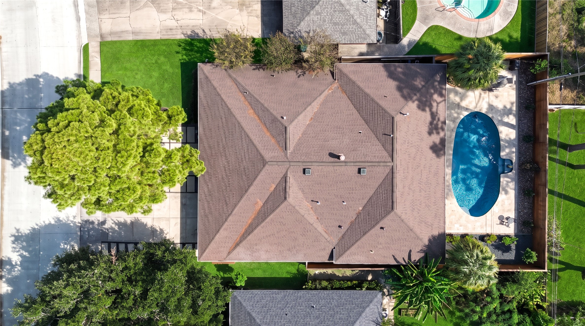 A top-down aerial view shows the home's footprint, the pool and the fenced rear yard on its established lot.