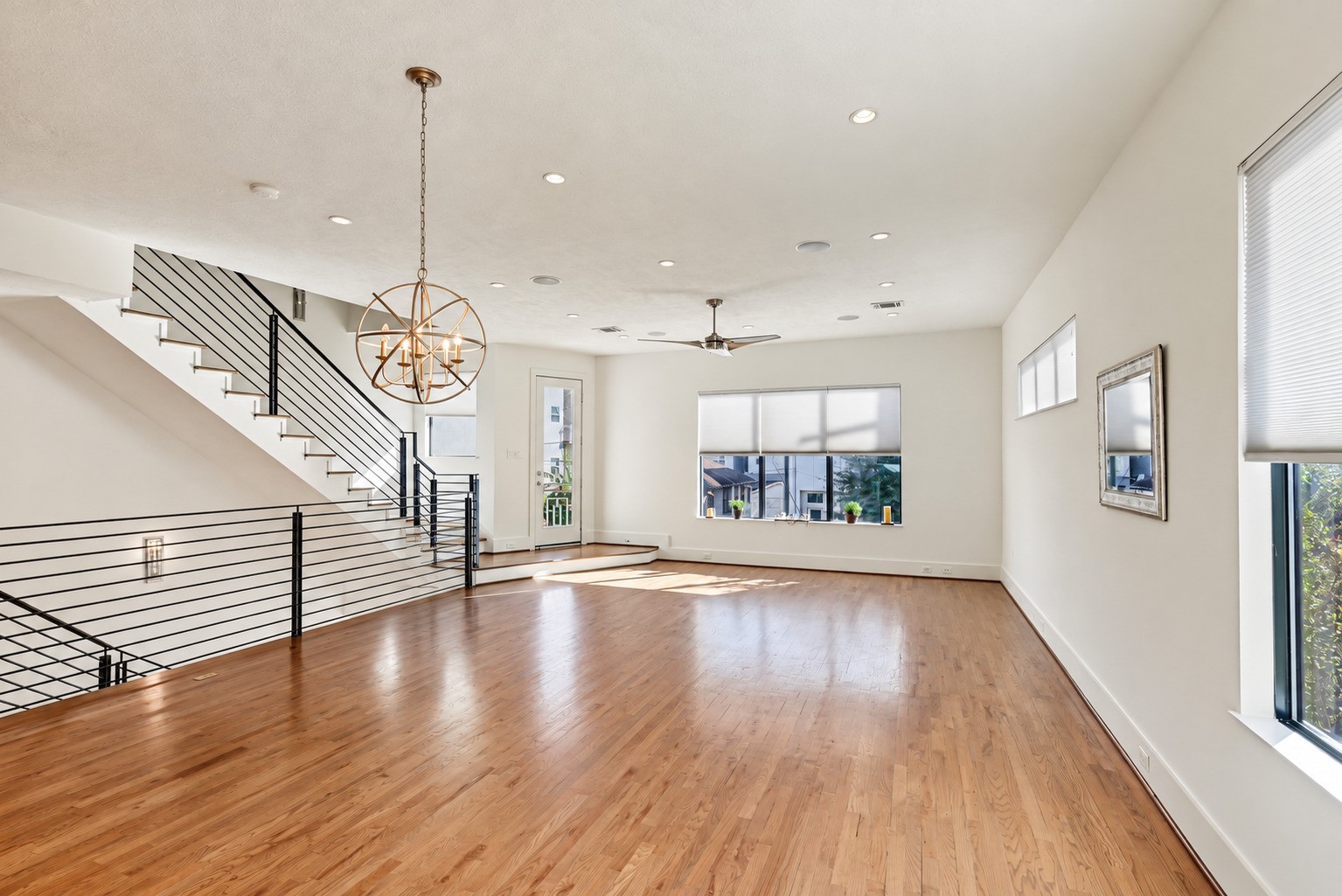 Gather, dine, and unwind across a light-filled main level tailored for effortless connection. Solid white oak flooring adds natural warmth to the open-concept living and dining areas, setting an inviting stage for both daily routines and lively entertaining.