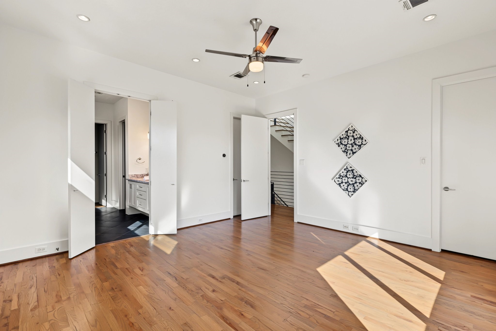 Sunlit and serene, this primary suite features warm white oak flooring and an elevated window design that maximizes natural daylight while keeping wall space open for your ideal bedroom layout.