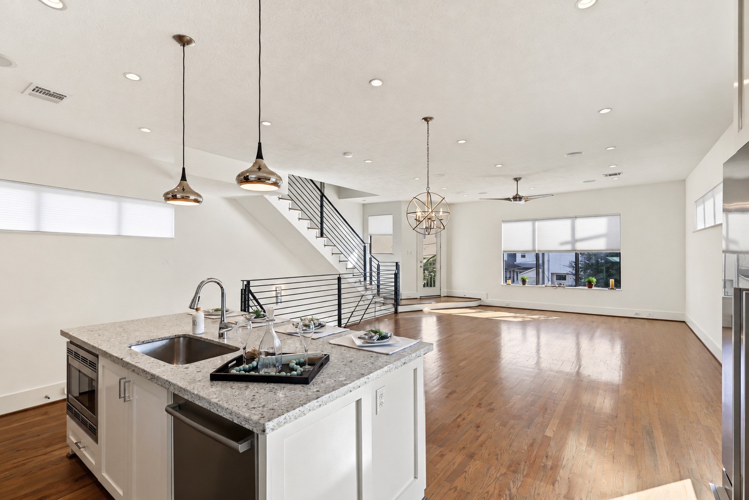 At the center of the kitchen, a sleek quartz island effortlessly brings meal prep and conversation together. Illuminated by designer pendant lighting, the integrated breakfast bar and seamless flow to the living area ensure the chef remains right in the middle of the gathering.