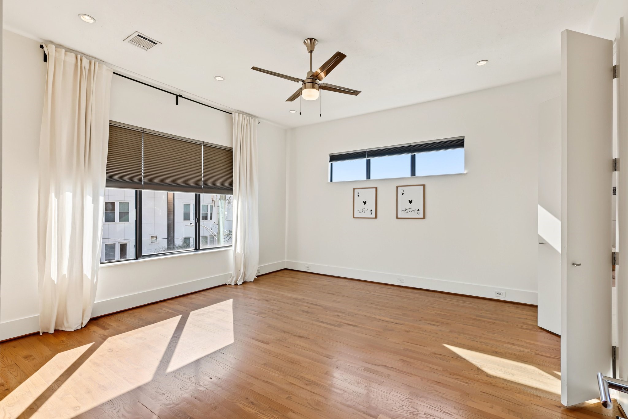 Unwind in a light-filled primary suite defined by warm solid white oak flooring and an airy, restful atmosphere. Dual walk-in closets provide generous, everyday storage to keep your retreat clutter-free, while sweeping views of the downtown skyline provide a dramatic backdrop from morning to night.