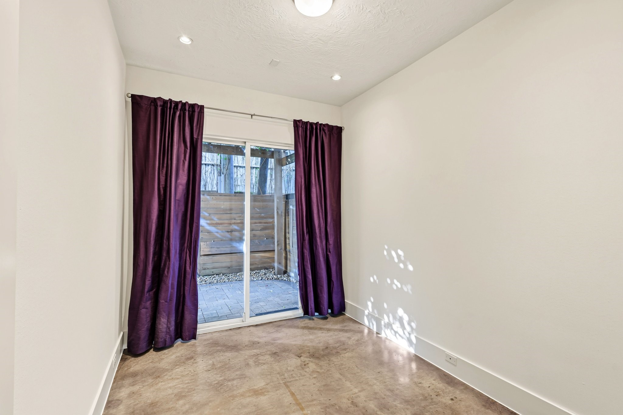 Open the door to effortless versatility. Seamlessly opening to the private backyard, this ground-level bedroom or study serves as a secluded guest suite, a light-filled home office, or a peaceful everyday sanctuary with immediate outdoor connectivity.