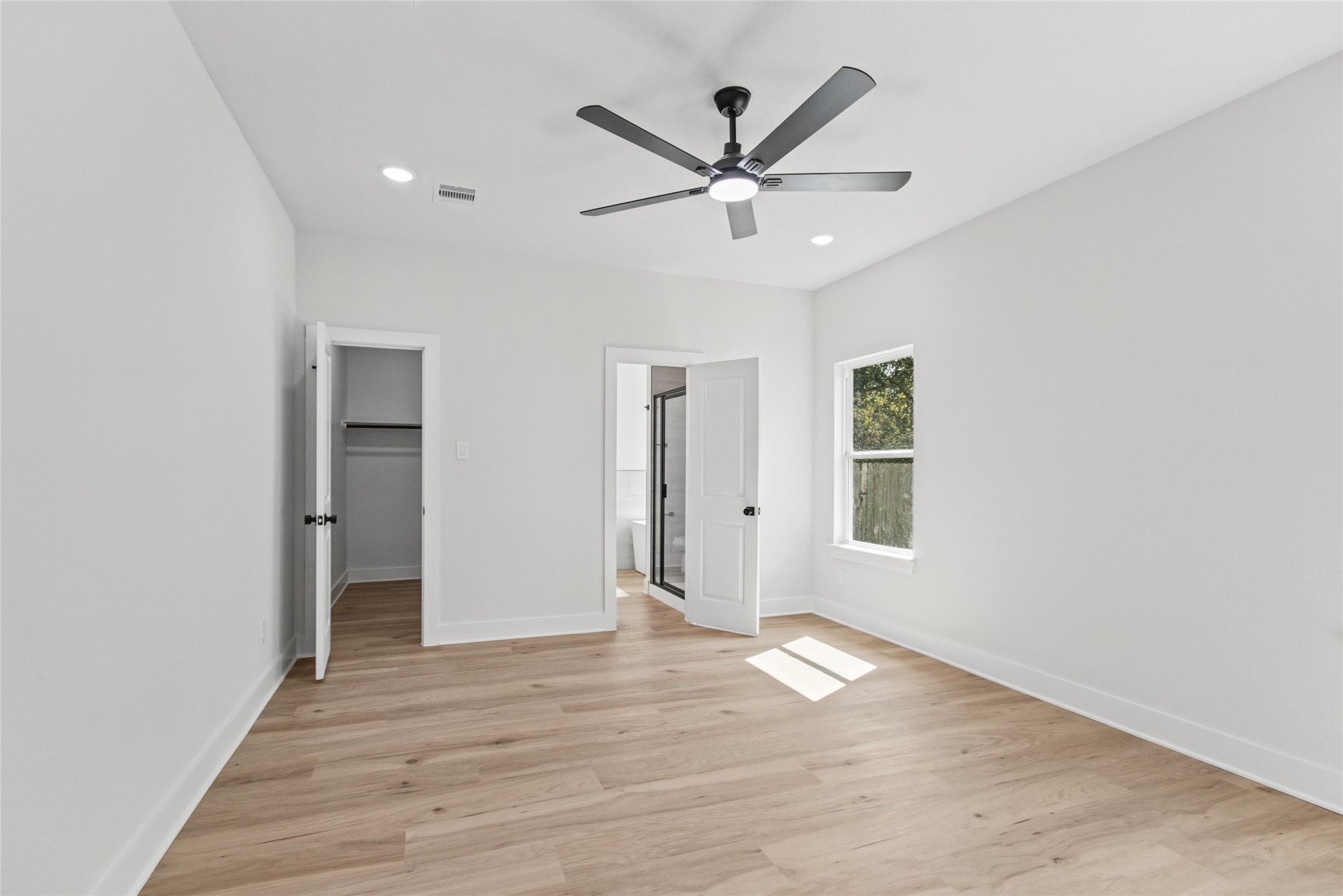 Primary Bedroom with walk-in closet and bathroom