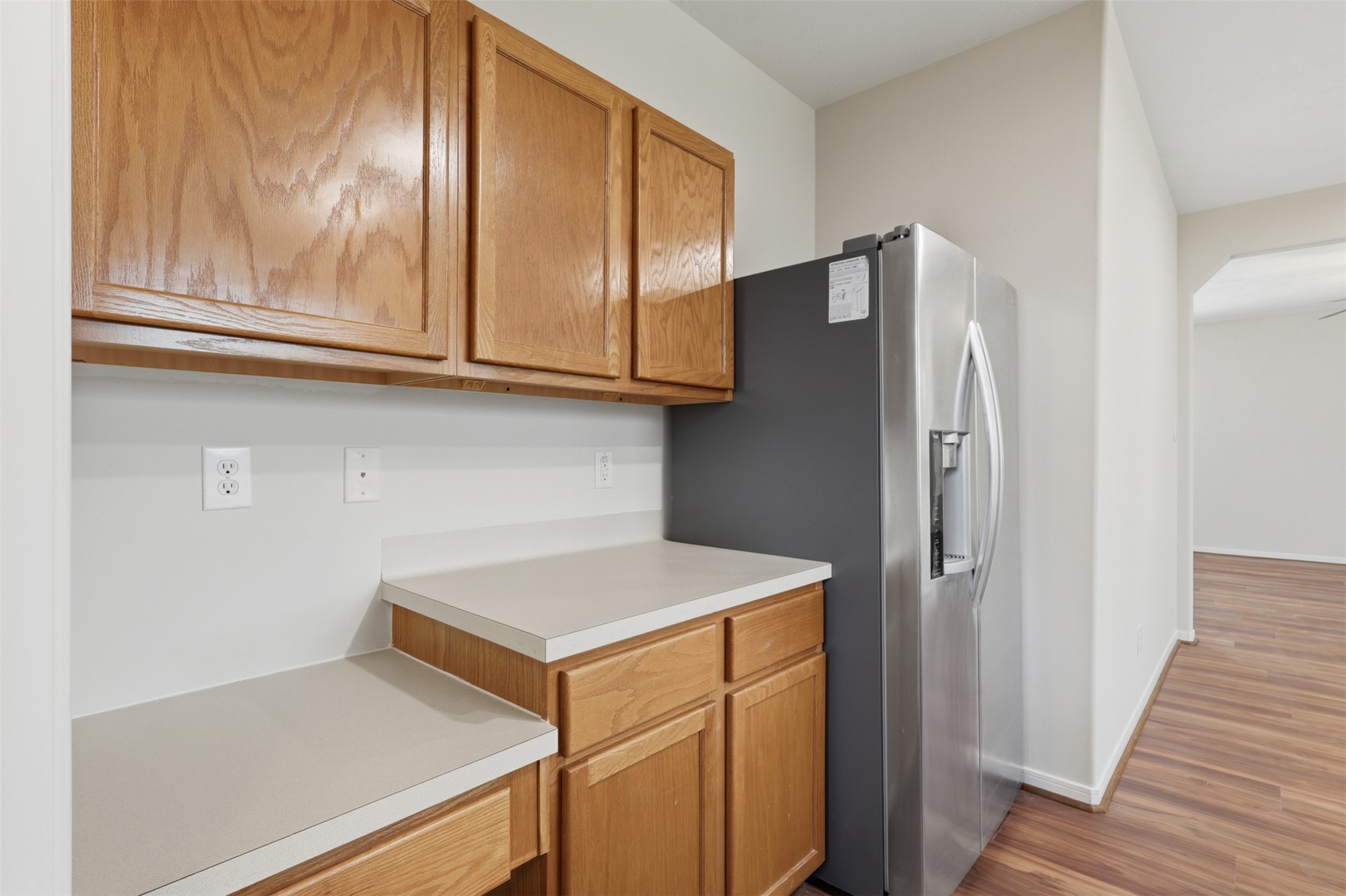 Spacious kitchen work area featuring abundant oak cabinetry, generous counter space with convenient access to the adjoining living areas.