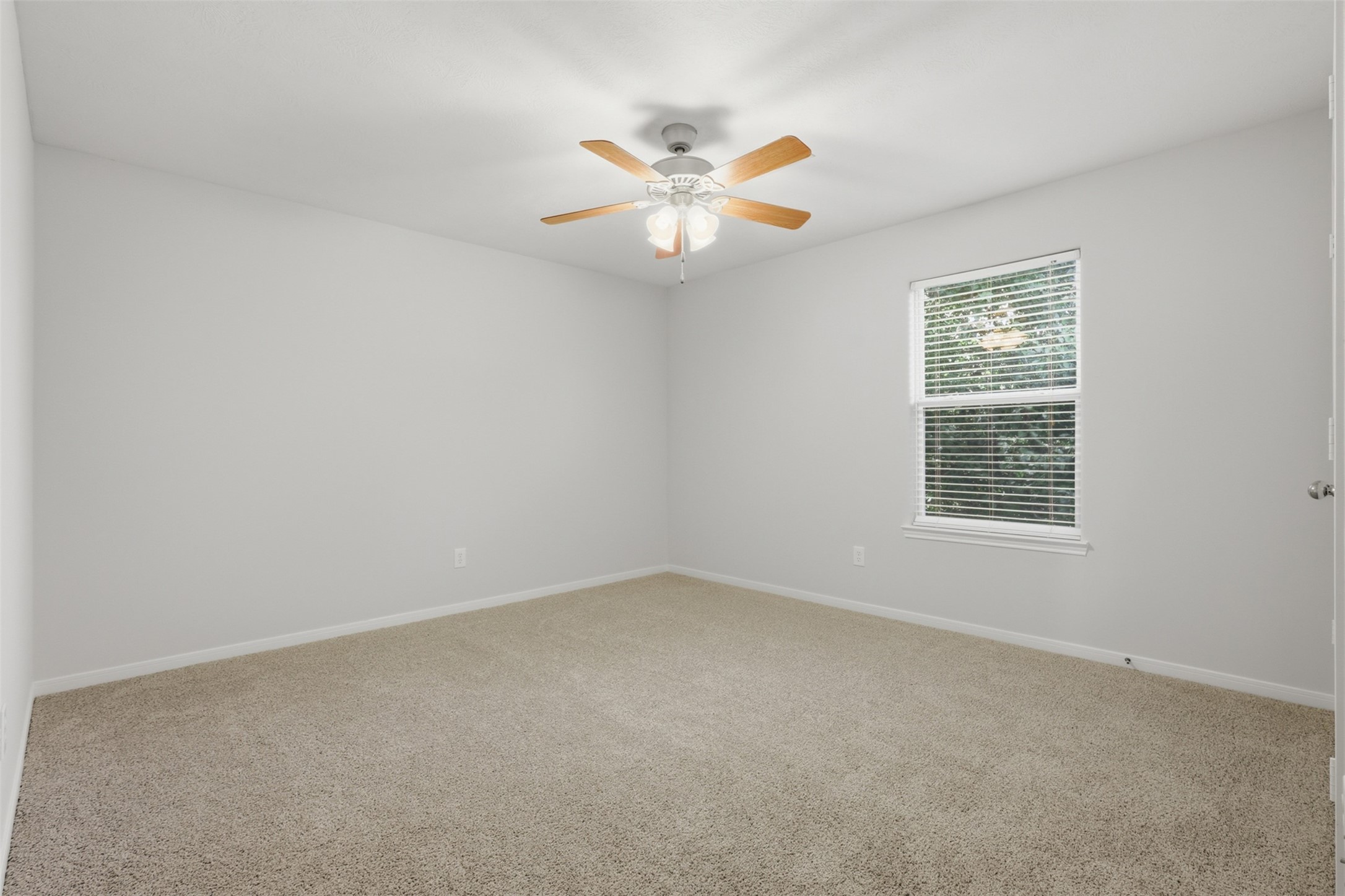 Secondary bedroom featuring fresh neutral paint that enhances the room's bright natural light, offering plenty of space for your furnishings.