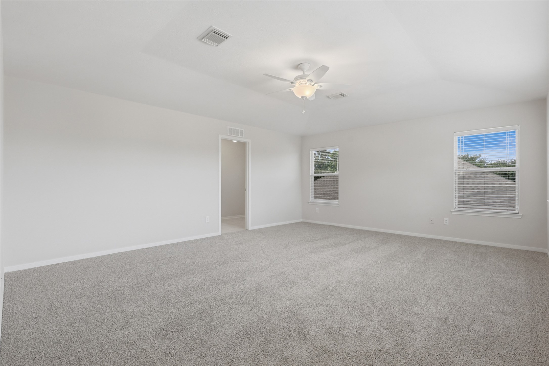 Generous floor space easily accommodates a king bed setup plus a cozy sitting area or reading nook.