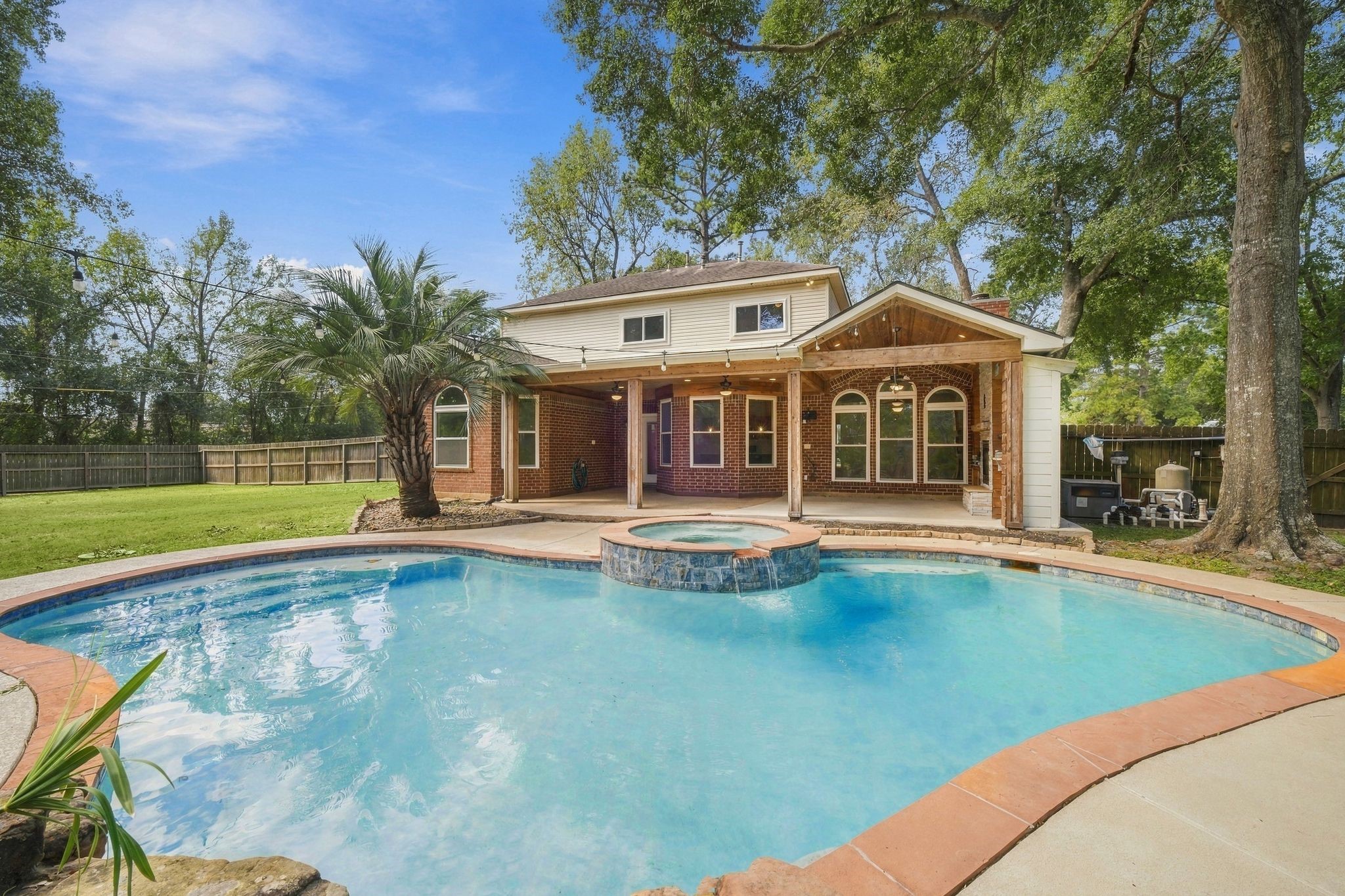 Look at this back yard! Sparkling pool, super cool covered patio with outdoor kitchen and fireplace all on an approximate half acre lot!