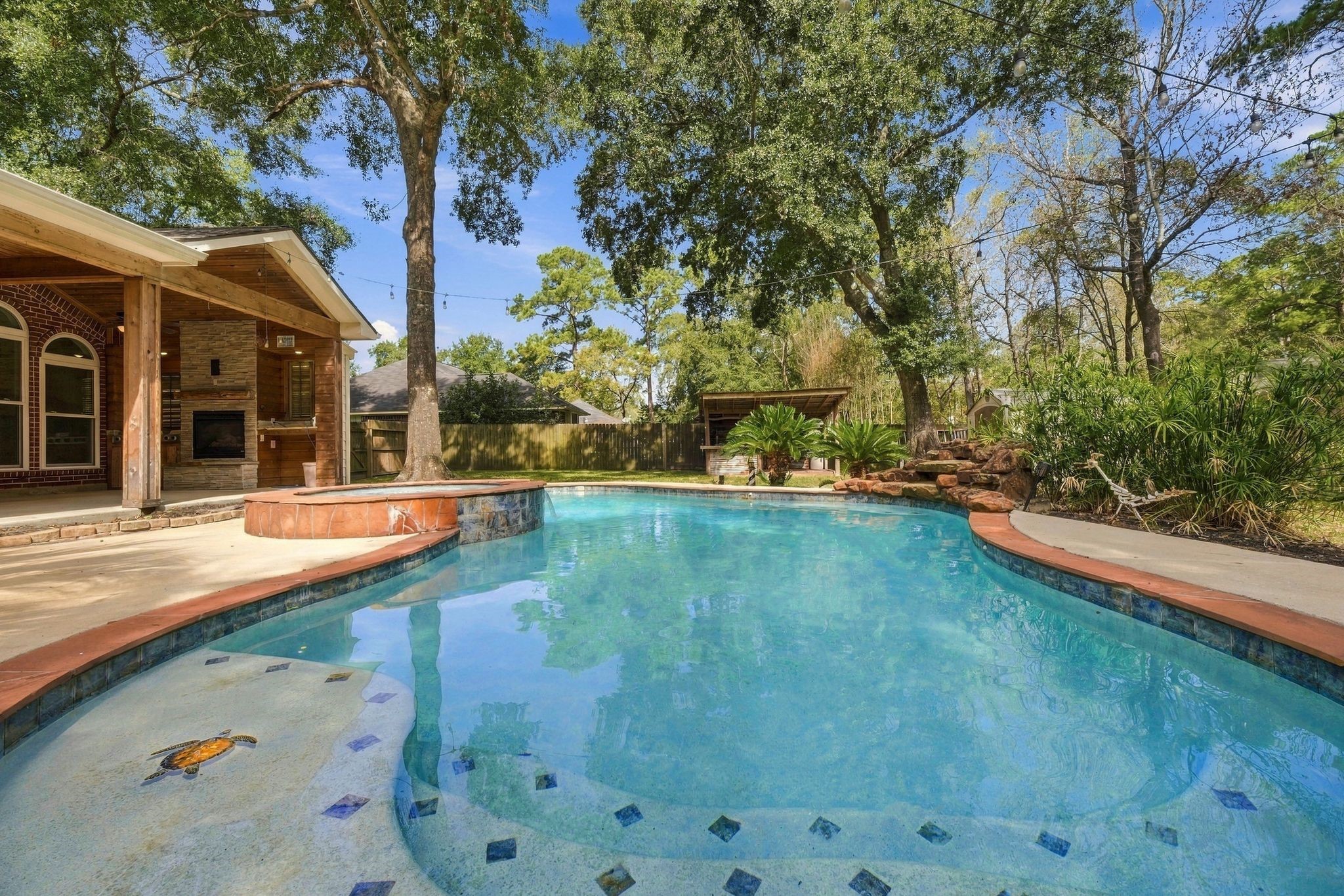 From the pool you can see the covered patio with outdoor kitchen and fireplace!