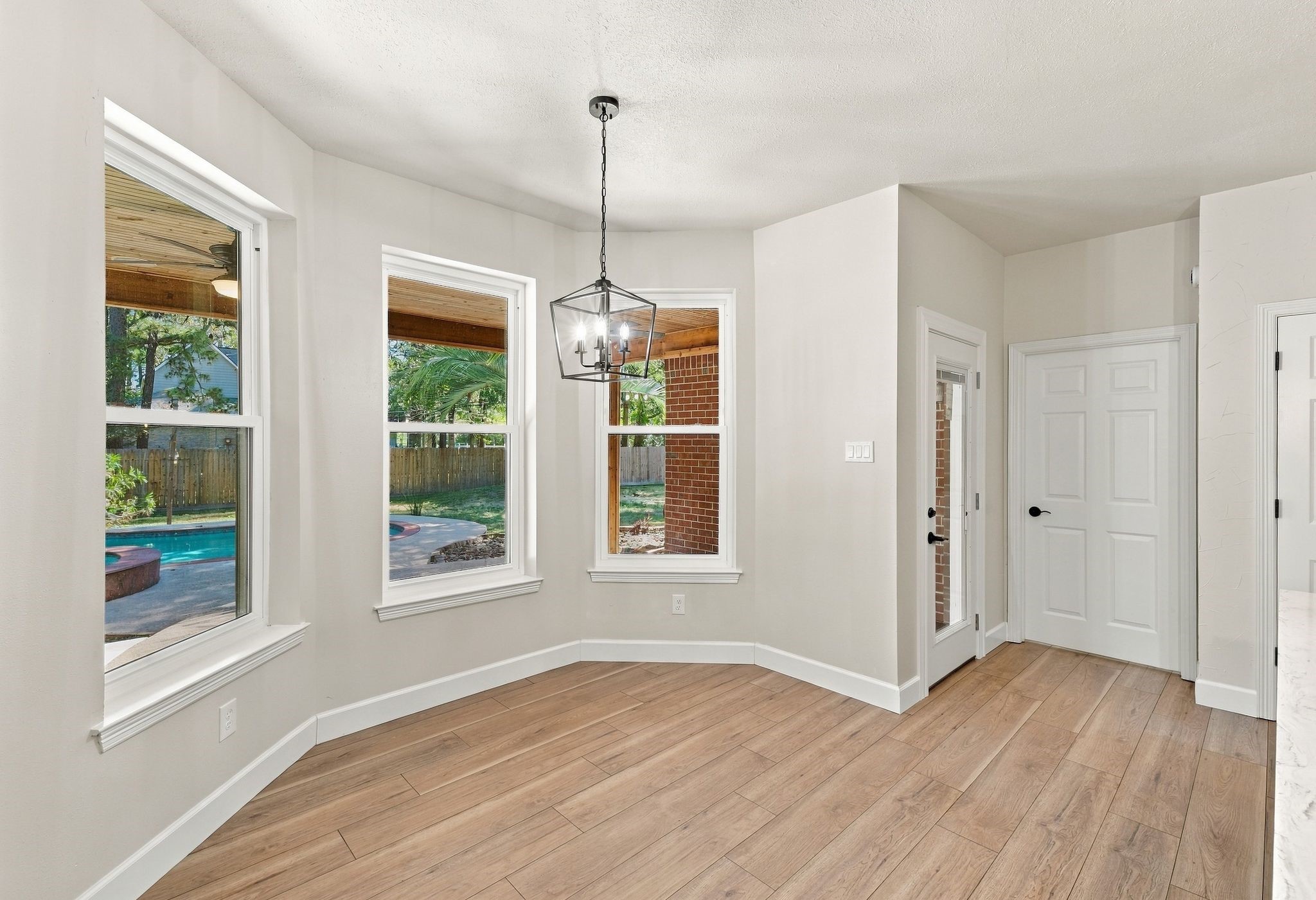 This breakfast room is completely open to the living room and to the kitchen! It has updated lighting, flooring and paint!