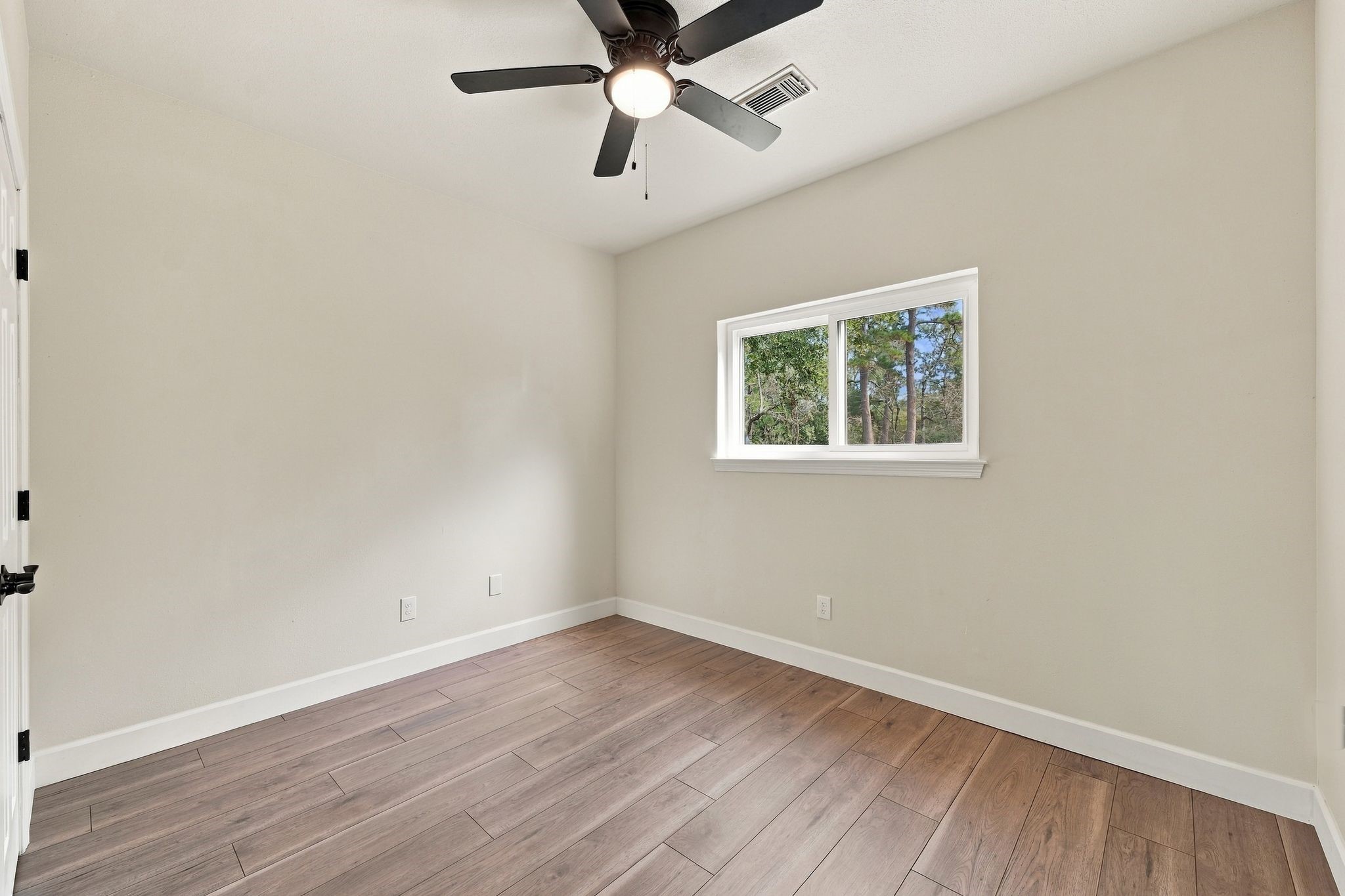 This secondary bedroom is upstairs and has updated flooring and lighting and a great view of the back yard!