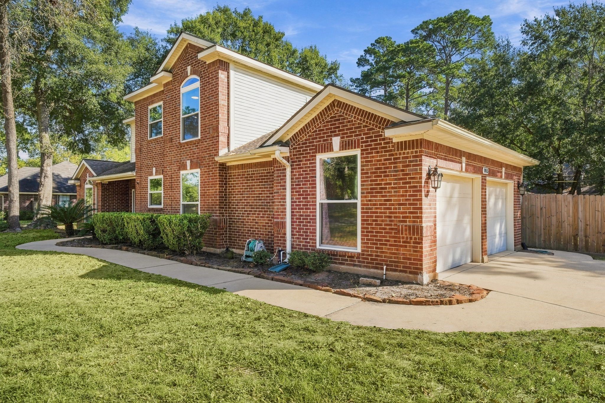 Two car attached garage with a double driveway near the garage.