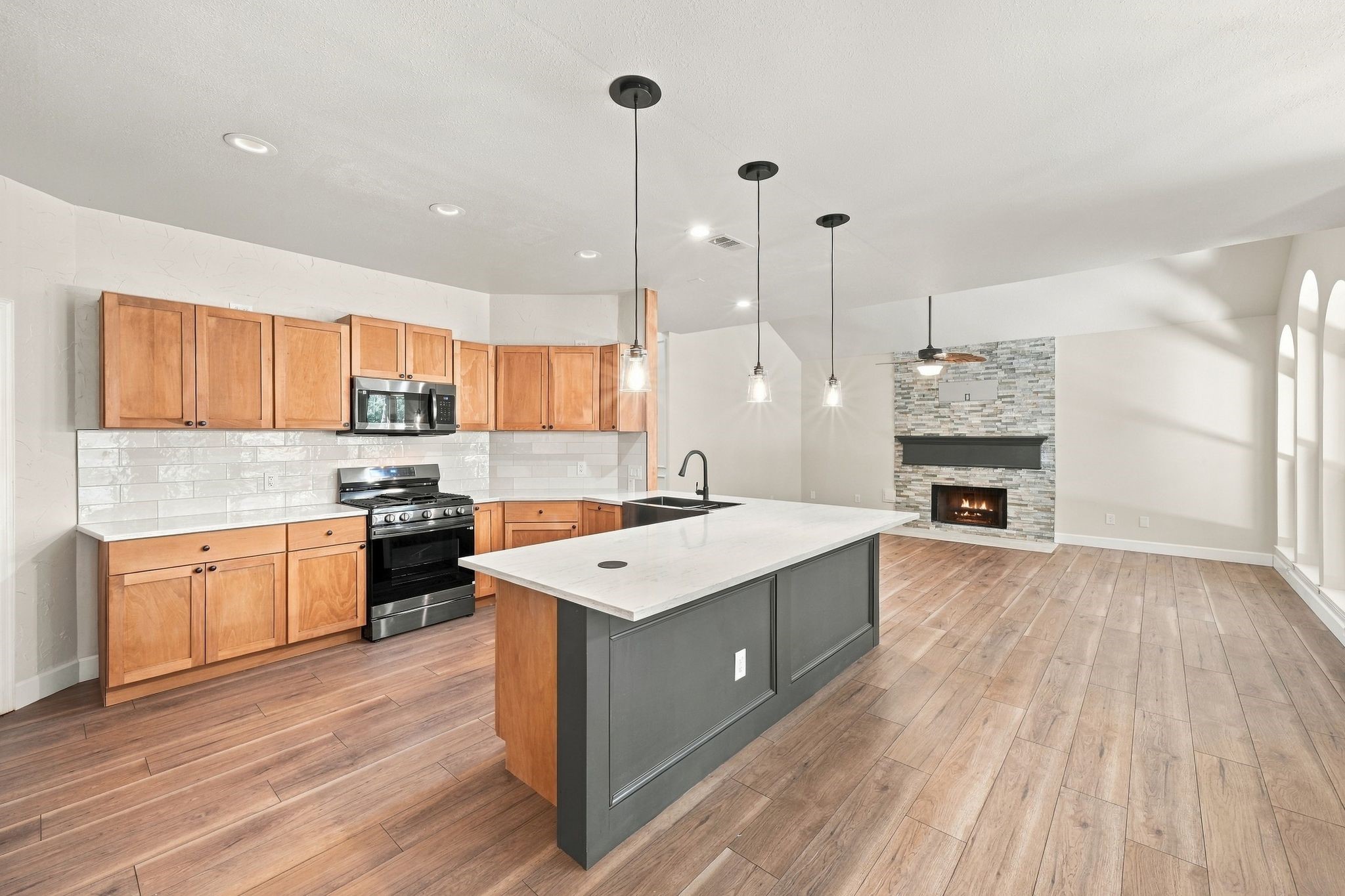 Look at all of this space! Your house will be the place to entertain! Updated tile back splash, and a pop up power outlet in the top of the island!
