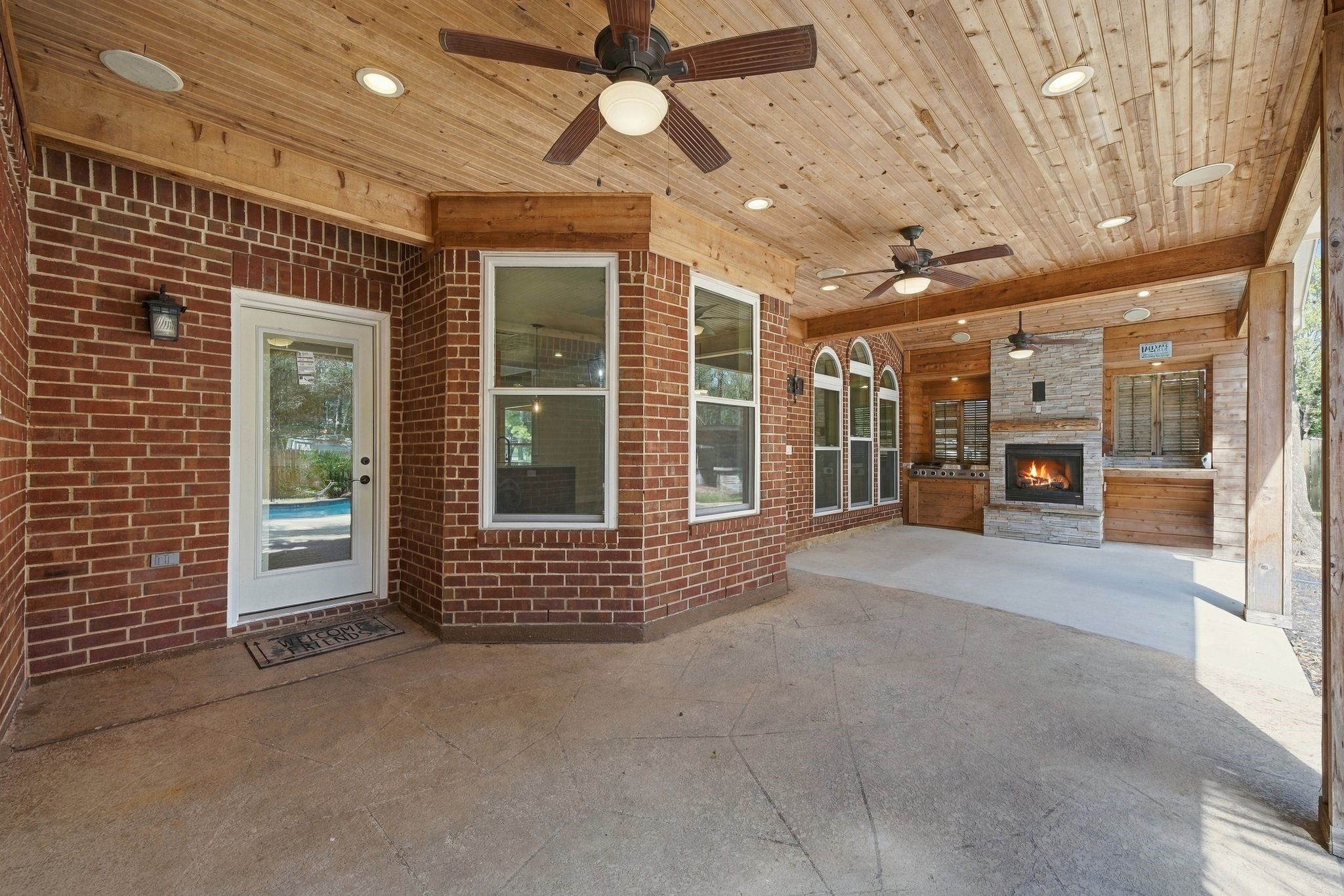Swoon worthy!!! This will be your favorite spot! Friends, games, parties, cookouts! This is the place! Look at that custom wood paneled ceiling! The updated lighting, the outdoor kitchen, the fire place!!