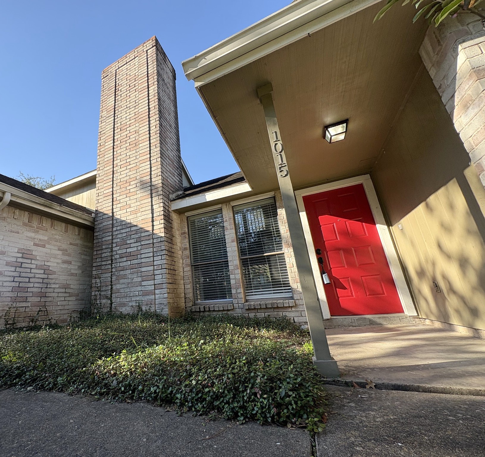 Bright and cheerful red front door welcomes your guests in style