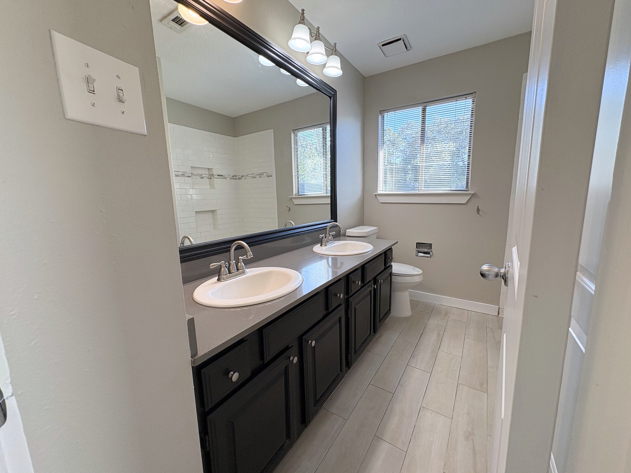 Beautiful updated bath upstairs features custom tile and granite