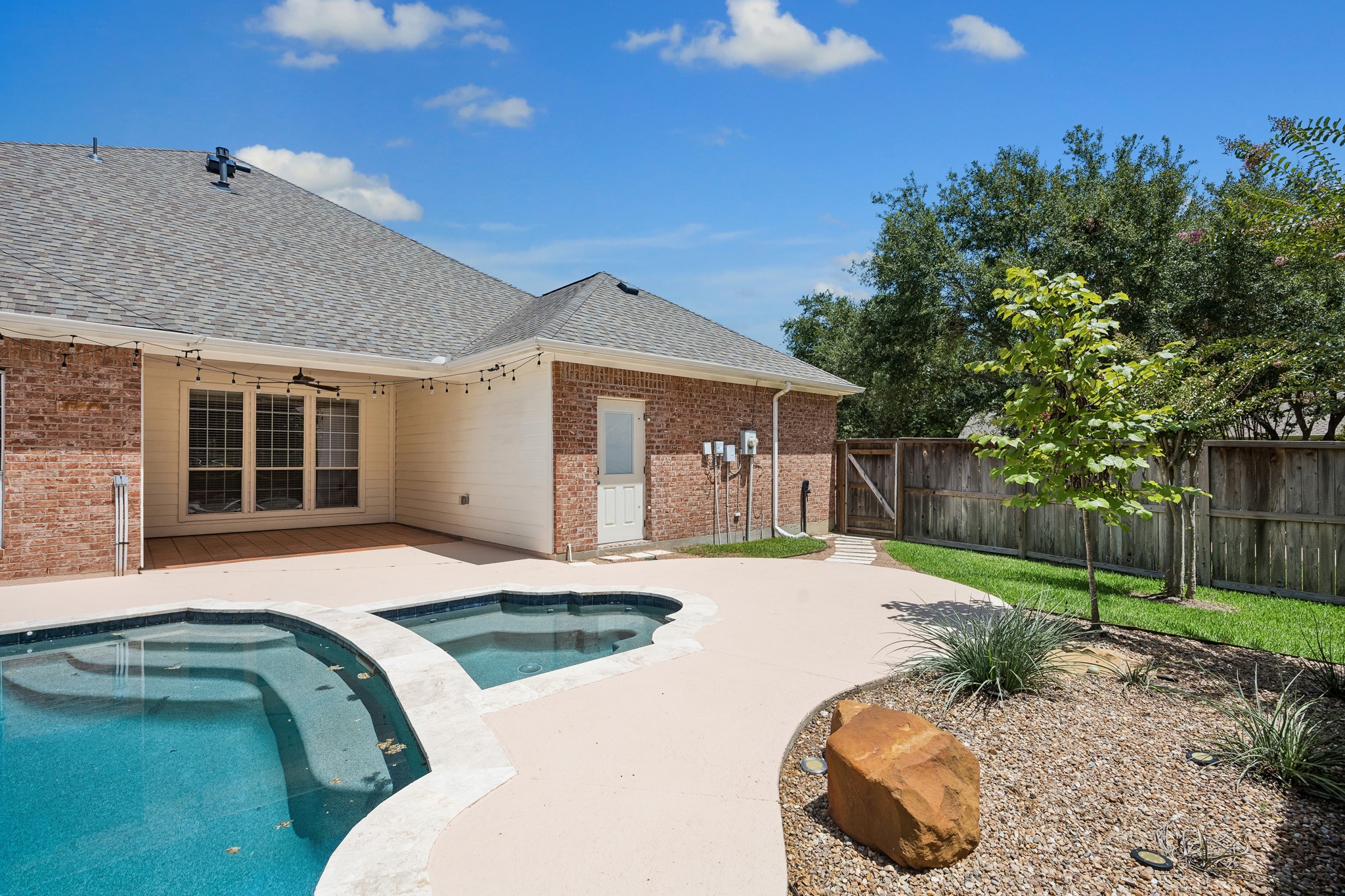 Beautiful backyard retreat featuring a recently updated pool with PebbleTec, new coping, travertine border, and heat-resistant paint. Mature landscaping and generous outdoor space create the perfect setting for relaxing or entertaining.