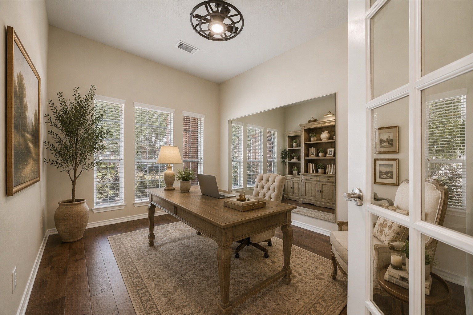 Virtually staged to showcase the possibilities, this inviting private study features beautiful engineered hardwood flooring, abundant natural light, French doors, and built-in shelving, creating an ideal space for a home office or quiet retreat.